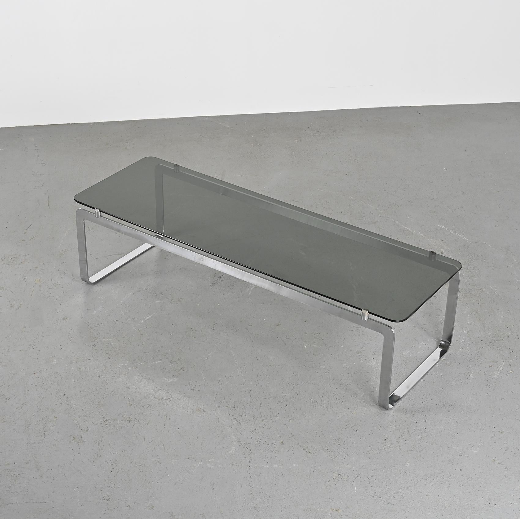 Elegant rectangular coffee table, P42 Model, envisioned by French designer Bernard Govin and crafted by Saporiti in the 1960s.

The sled-style base, constructed from chromed steel, gracefully encases a substantial smoked glass