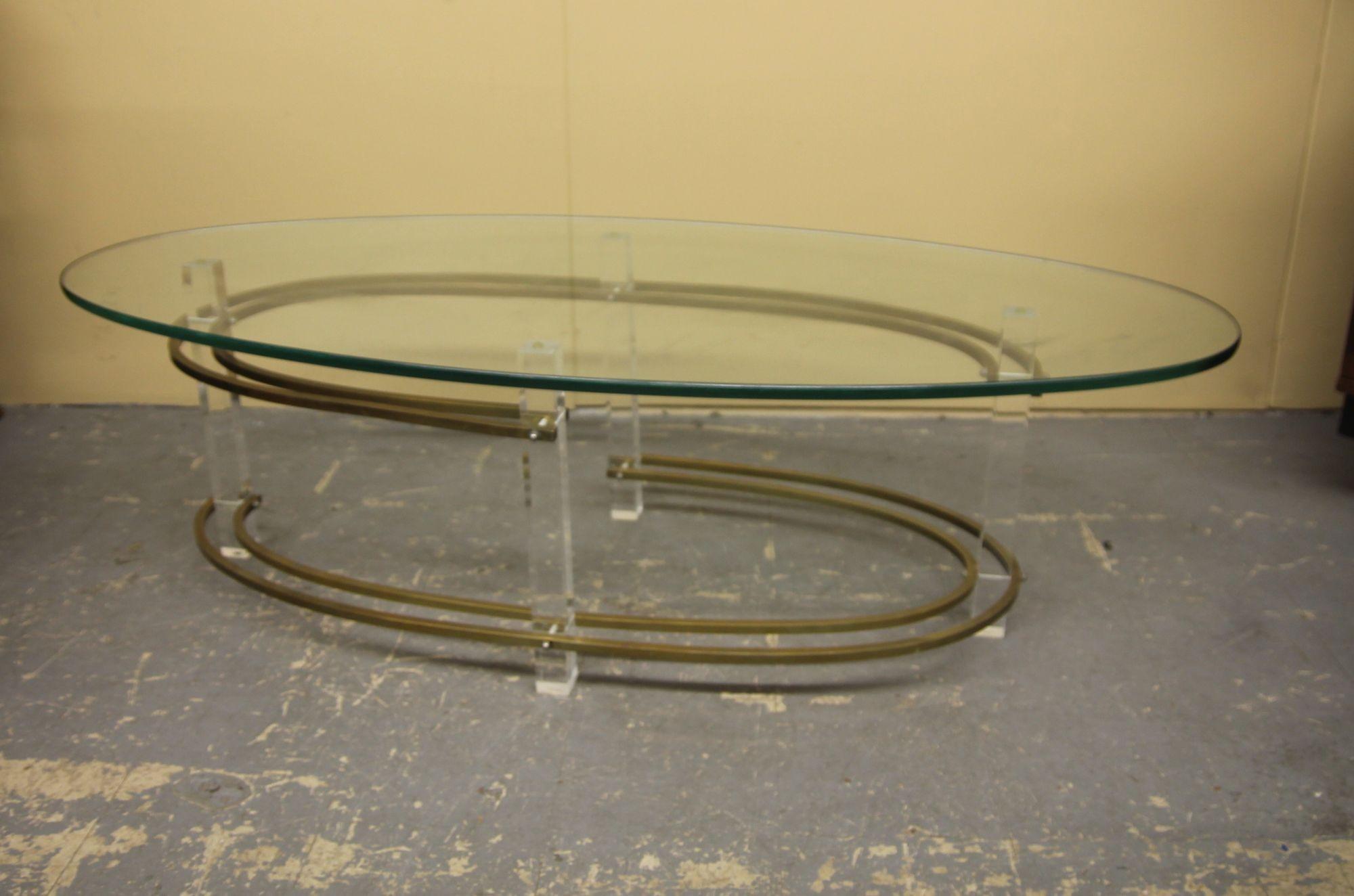 Pleased to offer this lucite, brass and oval glass top coffee table. Table is in great vintage condition. I just listed the matching side table as well.