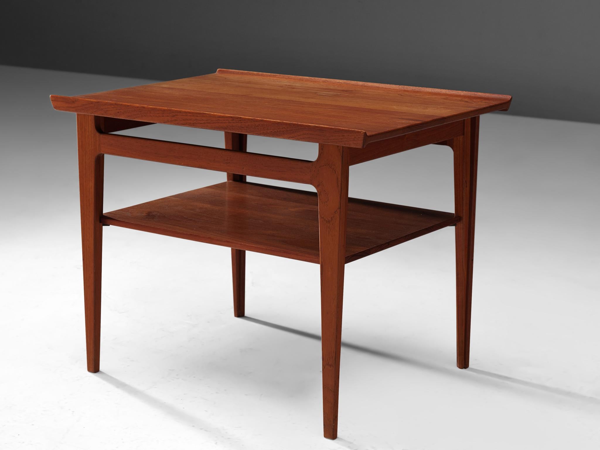 Elegant Coffee Table from the 500 series, by Finn Juhl for France & Davoricksen, coffee table, teak, Denmark, 1958.
 
This solid teak coffee table was part of the 500 series that included a square and a rectangular side table with the common feature