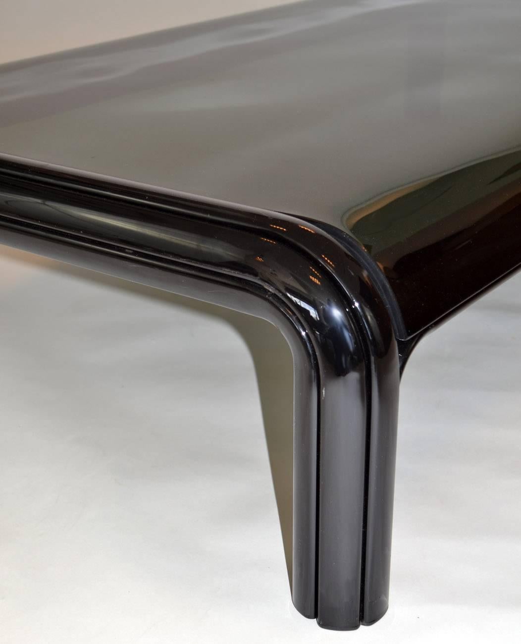 Coffee table by Gae Aulenti for Knoll International, 1975. Seldom-seen rectangular form in black enameled channel metal with curved smoked glass top. A sleek, sexy table.