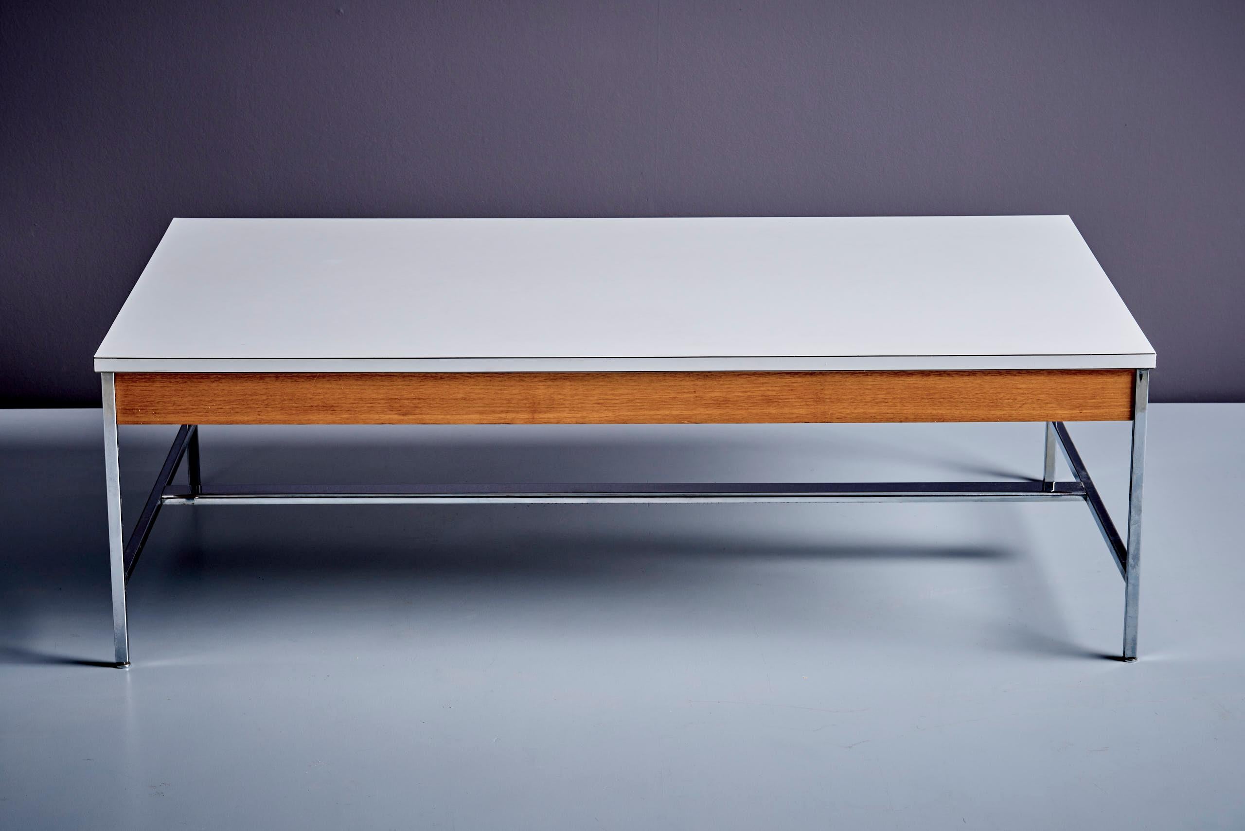 Rare Model 5751 coffee table by George Nelson for Herman Miller. Features a white laminated top, polished steel base, and mahogany apron. Retains original label. A clean, iconic example of mid-century American design. Vintage condition with wear and