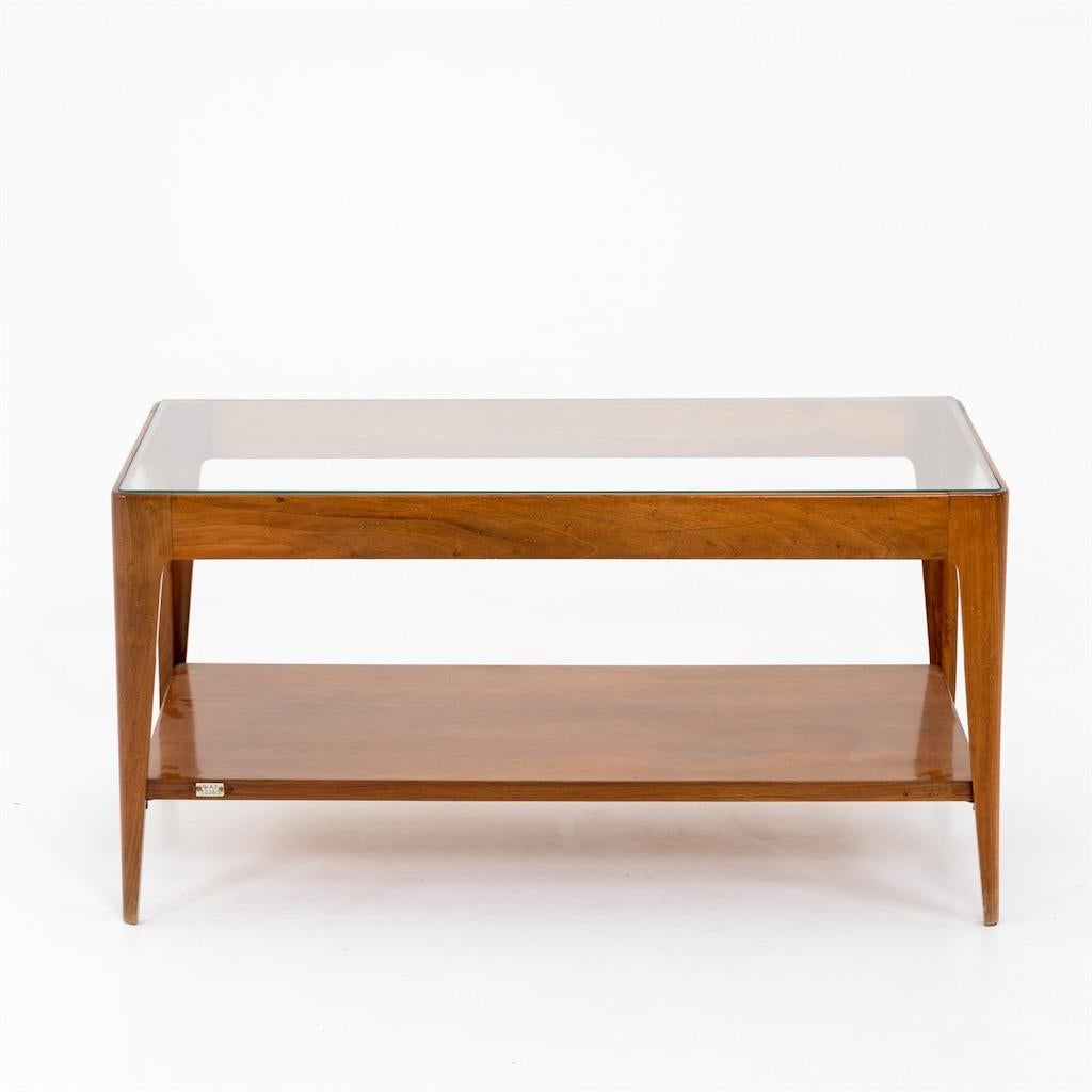 Wooden coffee table with glass top and tapered legs. The table is numbered 10360; an expertise of the Gio Ponti Archive is available.
