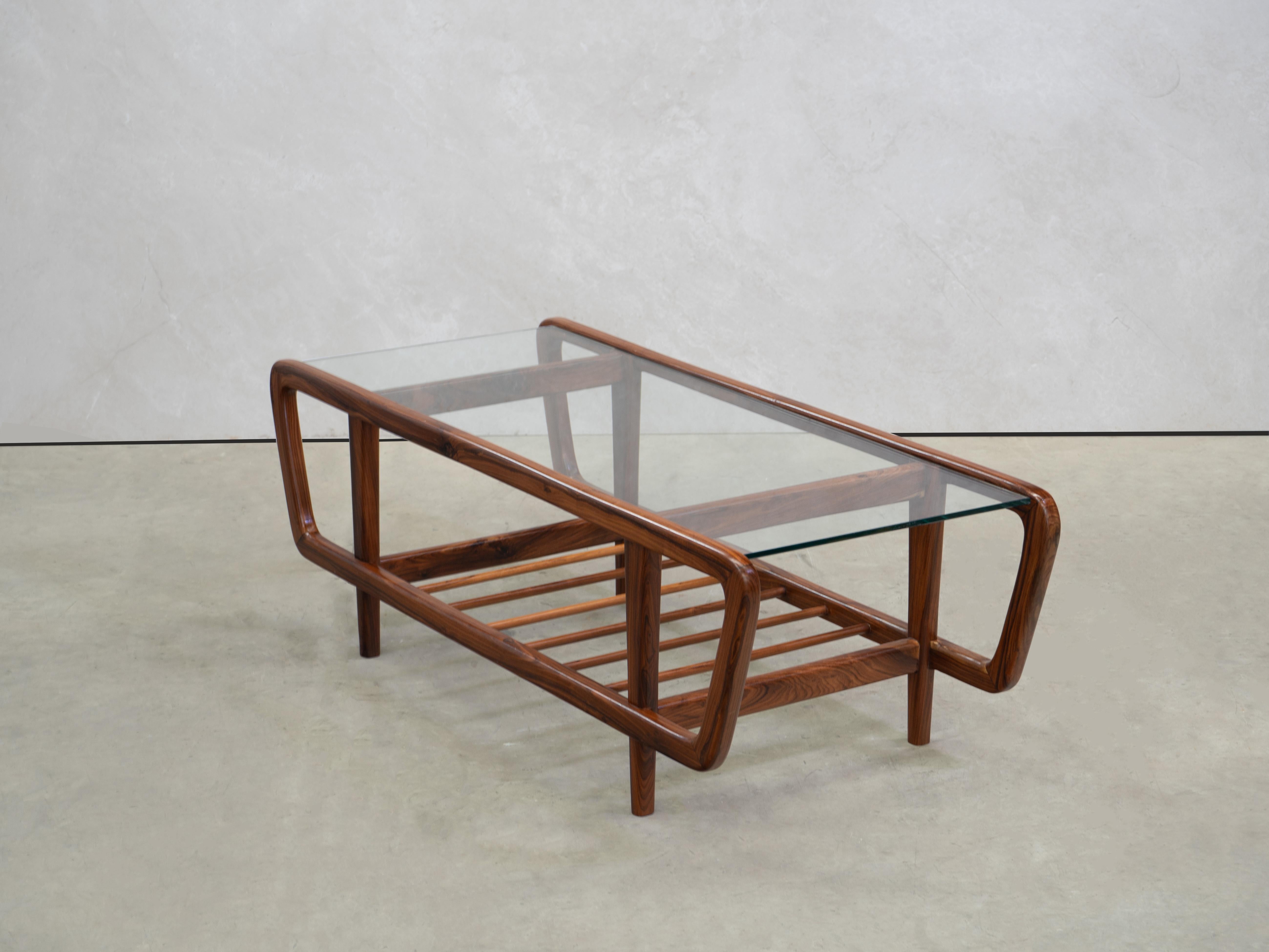 Designed by Giuseppe Scapinelli, the coffee table is made rosewood and has a glass top. The coffee table was softly restored.

A single structure, with curved lines, holds the glass, framing the piece and the straight tapered legs lift the table