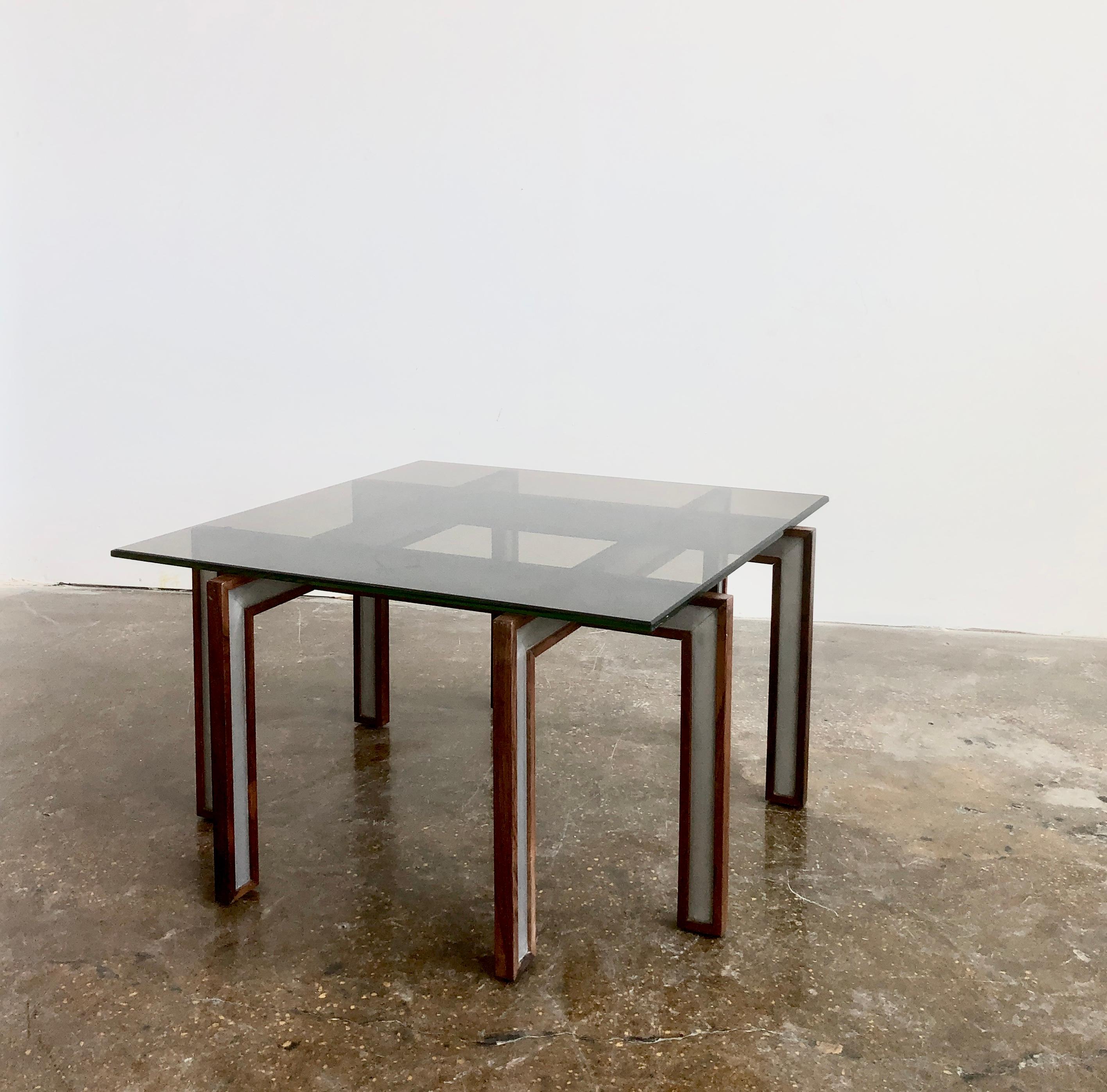 Coffee table of rosewood and metal with smoke glass top. Designed by Henning Korch, manufactured by C.F.C. Silkeborg. Denmark.
Some discoloration on glass top edge.