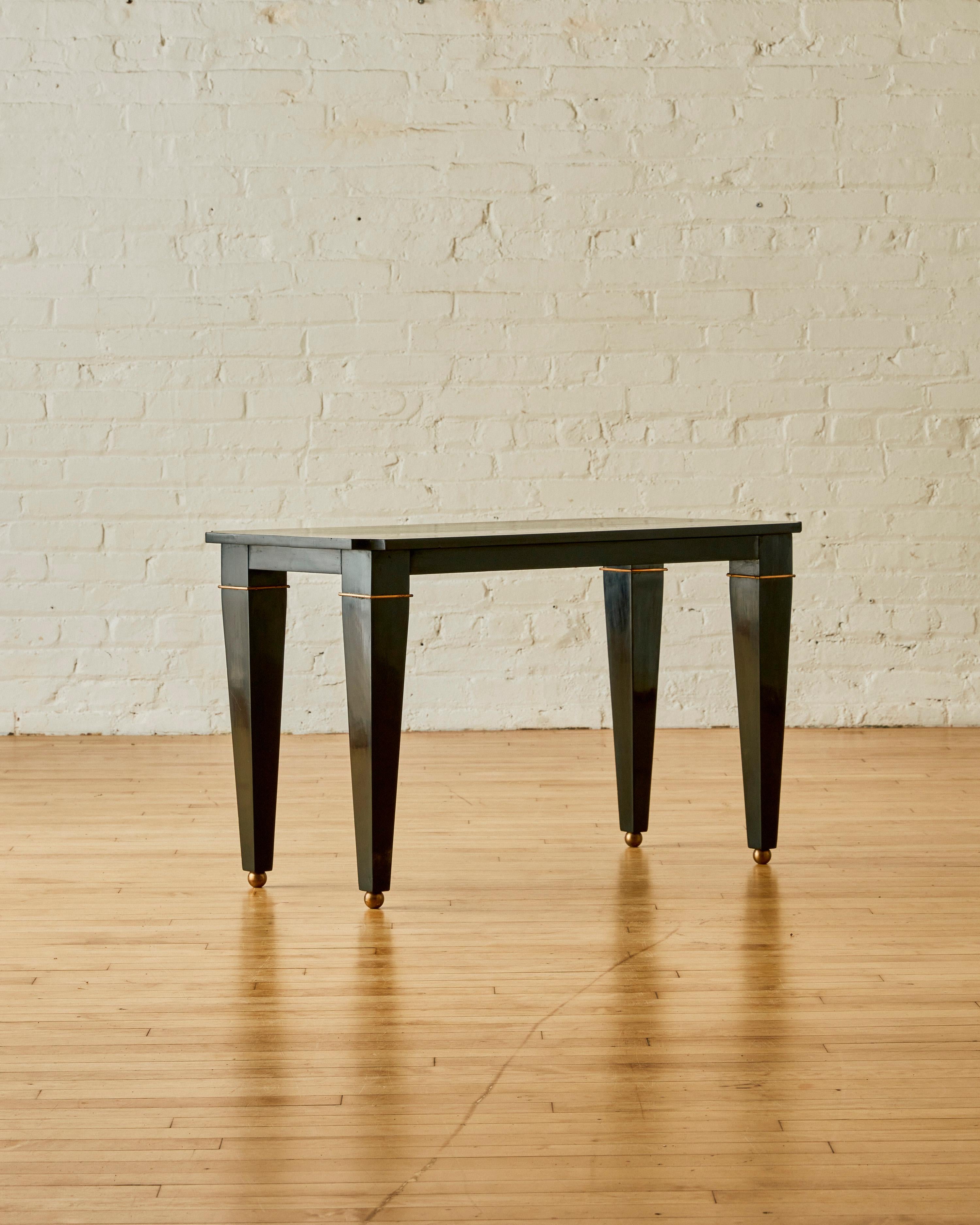 Coffee Table by Jean-Maurice Rothschild, c. 1940, in black lacquered wood with brass spherical gliders.

About Jean-Maurice Rothschild

Jean-Maurice Rothschild (1902–1998) was an interior designer and furniture artist, whose most famous works were