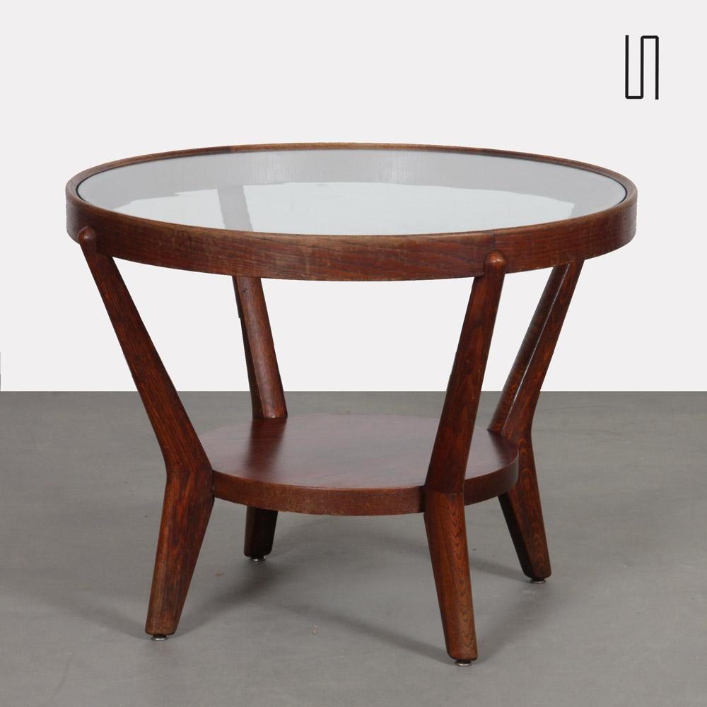 This coffee table was designed by Czech designers Antonin Kropacek and Karel Kozelka in 1944. In 1946, this table won the silver medal at the Triennale in Milan. The wooden frame is in good vintage condition. The glass top can be replaced with new