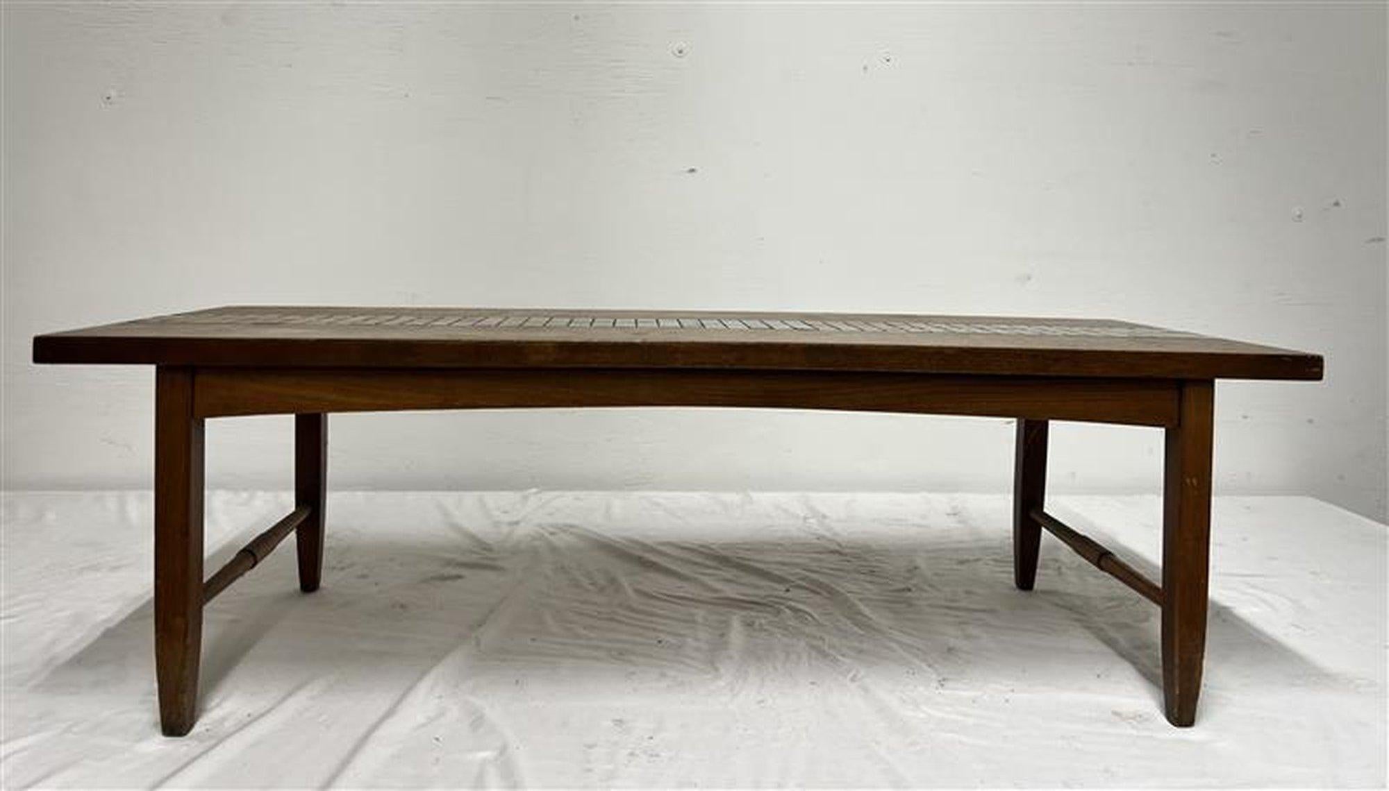 Mid Century Modern coffee table by Lane
It has a solid wood frame with inlaid cool gray tile ad tapered legs