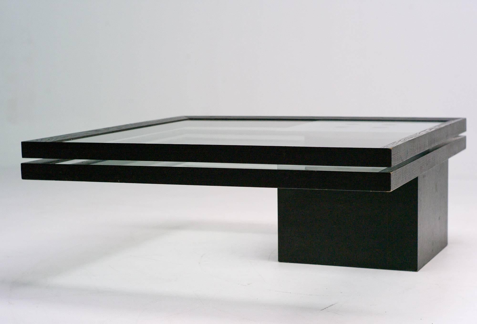Coffee table designed by Jean Pierre Cailleres for Ligne Roset, France.
Two glass table tops enclosed in black dye ash frames. The top one is fixed and the bottom one can swivel 360 degrees.

Excellent fast and affordable worldwide