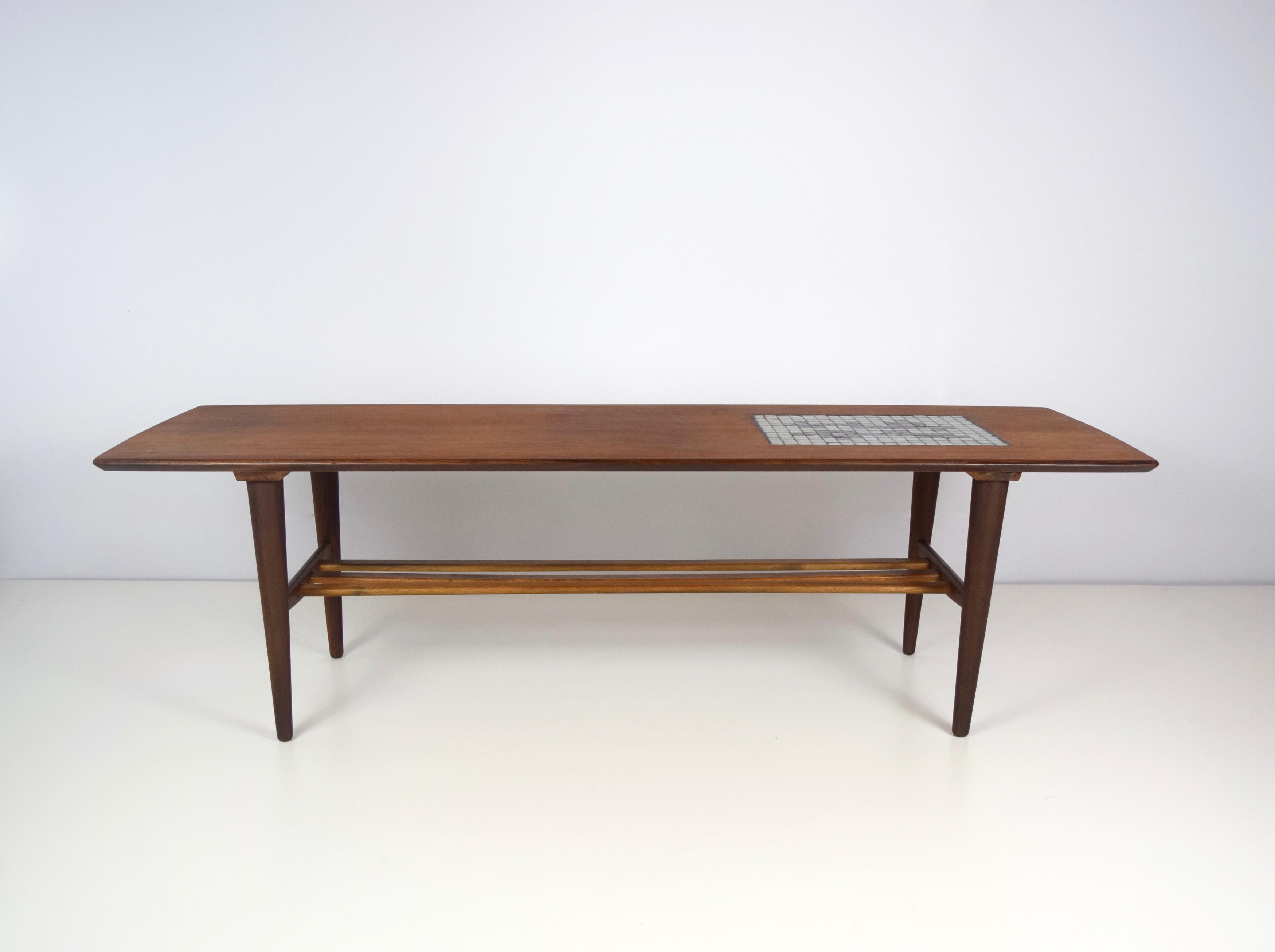 Beautiful coffee table by Louis Van Teeffelen with Mosaic of Jaap Ravelli for Webe, The Netherlands 1960s. This table is made of teak wood and has a magazine rack underneath the table. This table is also shown in the original Webe catalogus as
