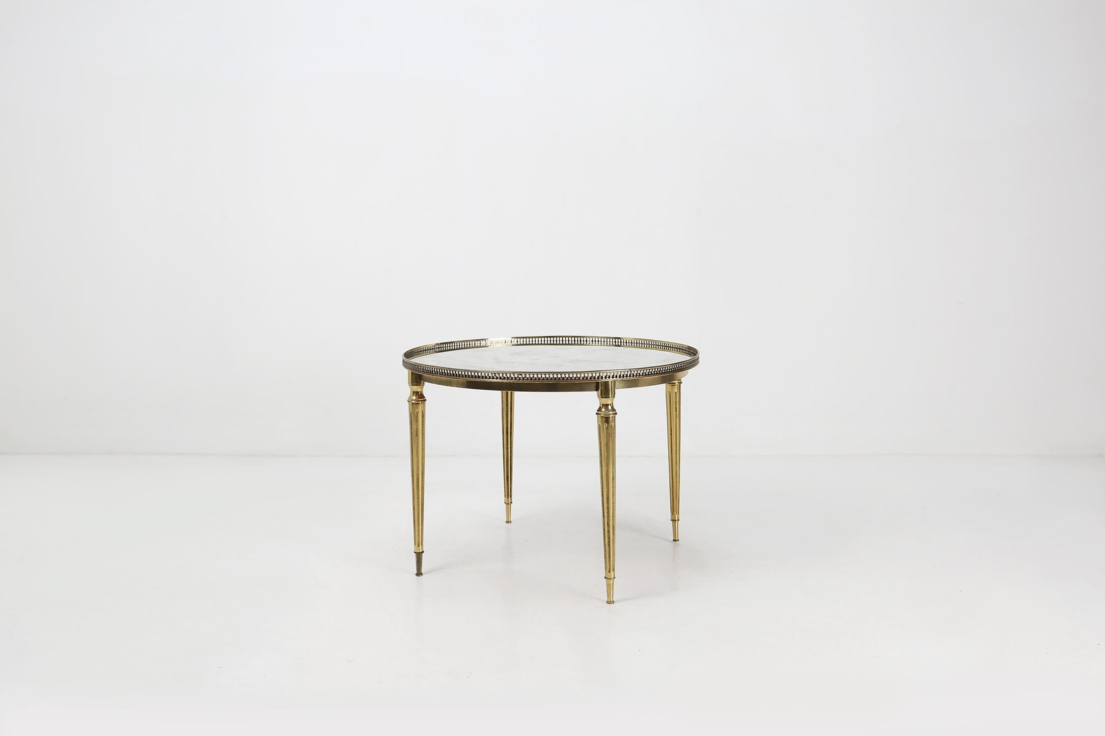 Coffee table by Maison Jansen produced in the 1950s with brass frames and smoked glass top.