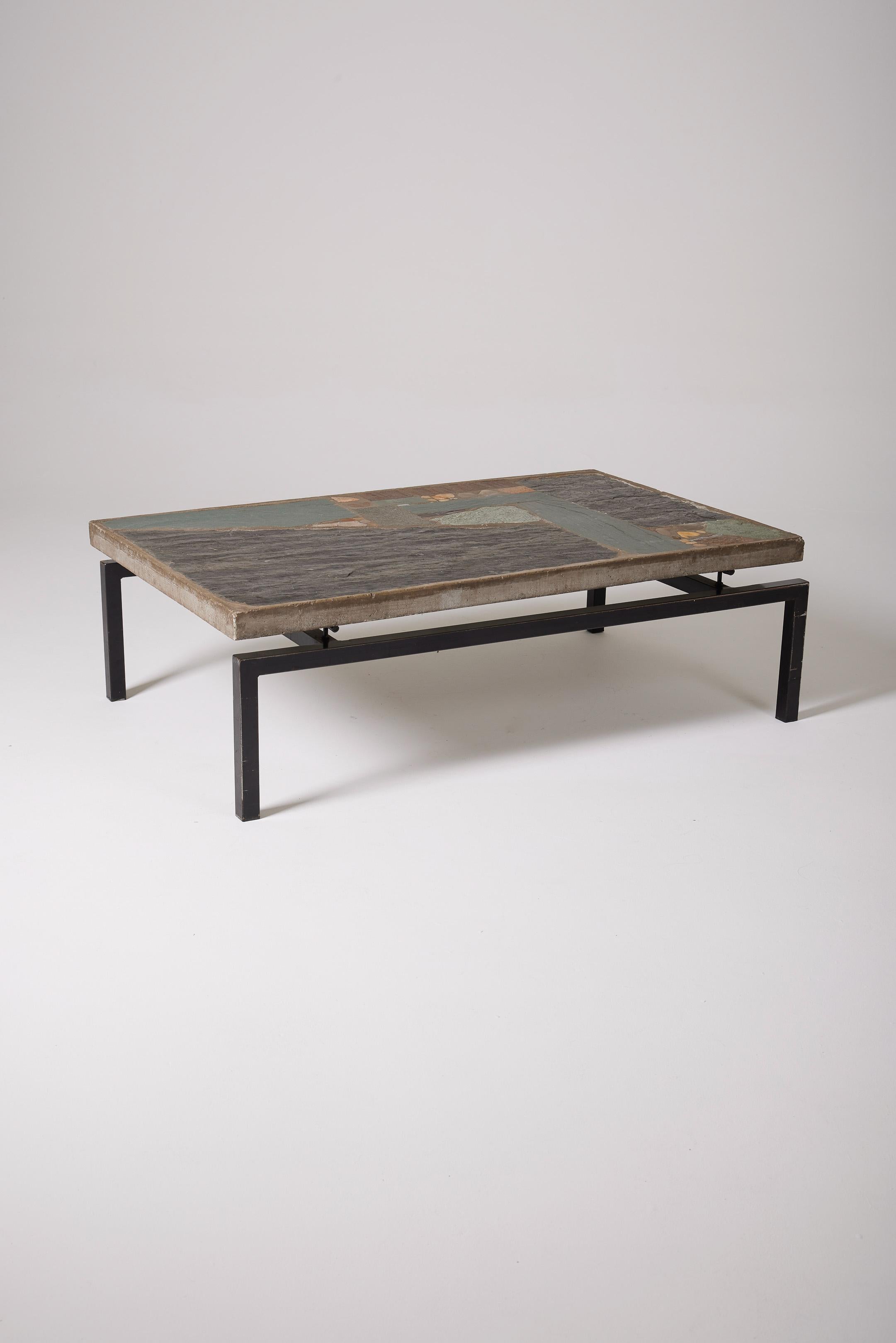 Coffee table by Dutch designer Paul Kingma (1931-2015) in the 1960s (1965). All his tables are unique creations. The table has a black metal structure supporting a floating concrete panel tabletop with inlays of slate and various stones. Beautiful