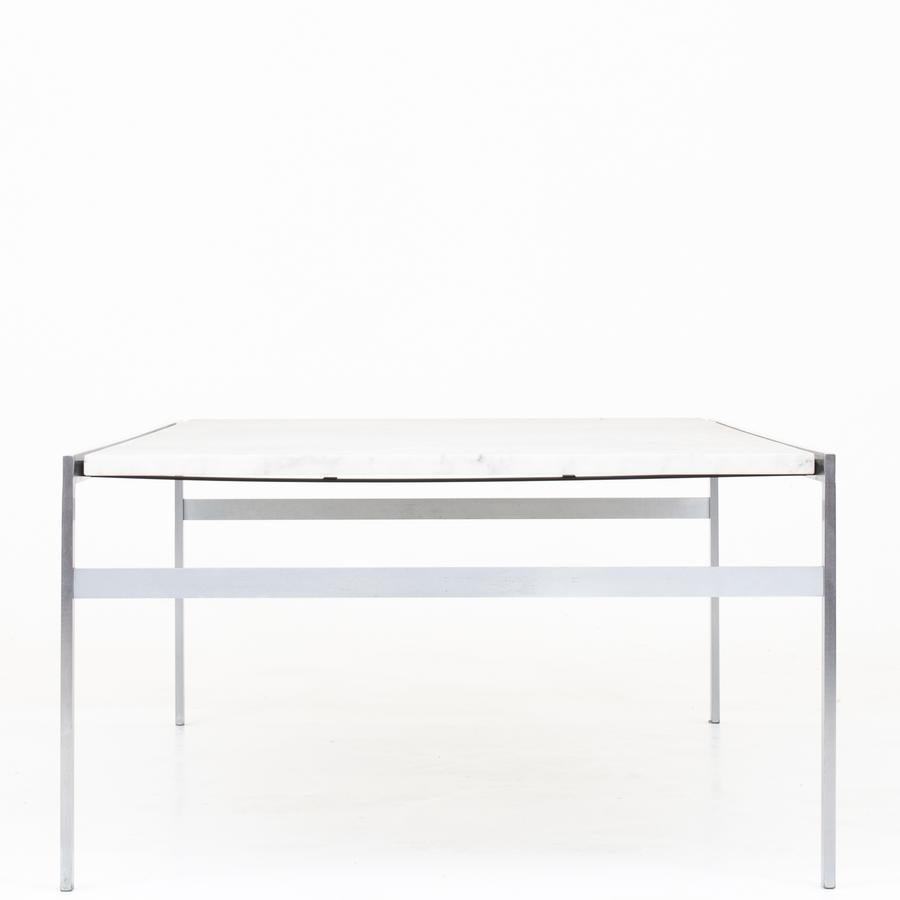 Coffee table with frame of matt chromed steel and top of light marble. Maker Bo-Ex.