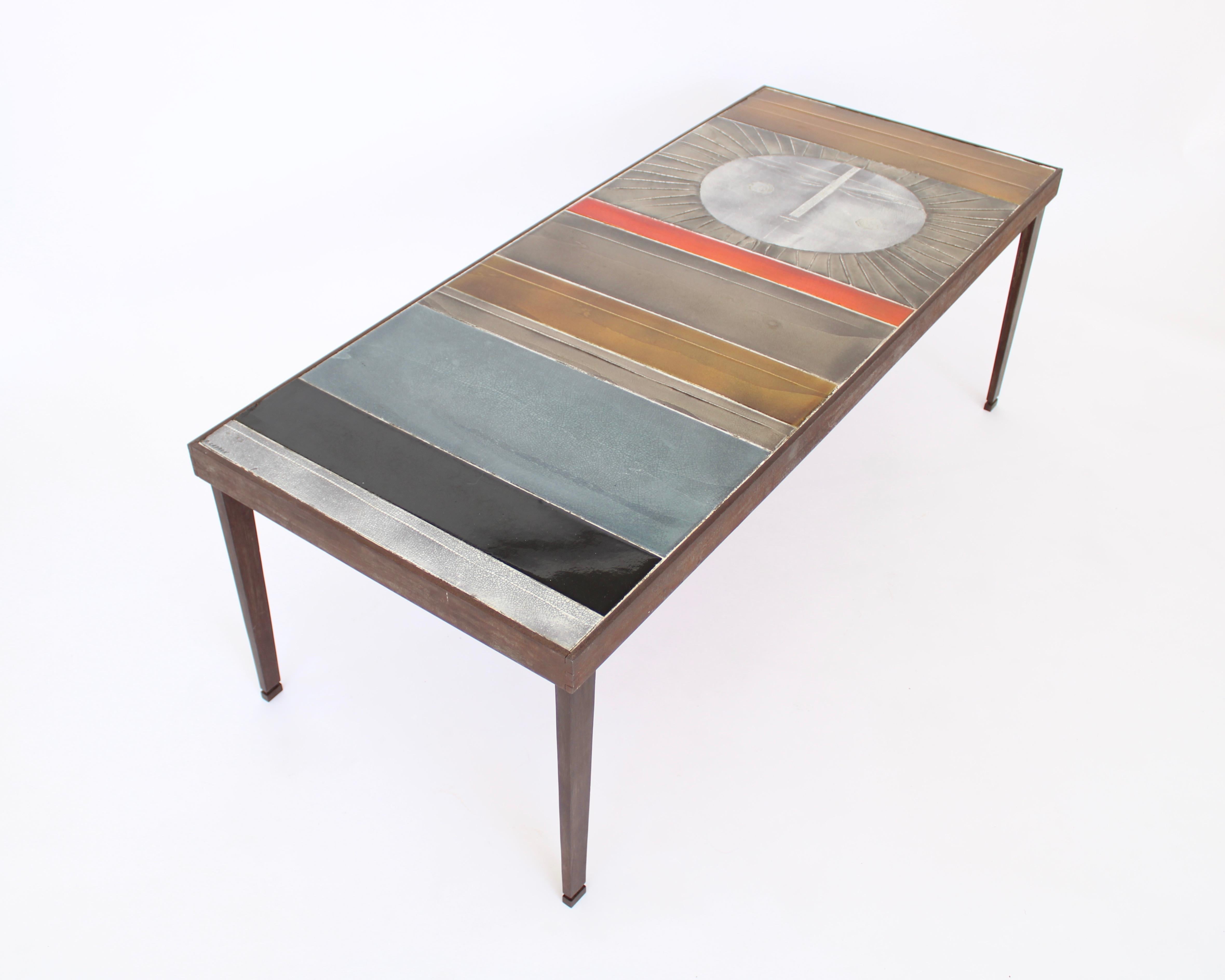 Exceptional table composed colorful abstract ceramics on a steel structure covered in, one of which is a large radiant sun. This is the large edition and an iconic piece by Roger Capron, one of the greatest post war French Ceramicists.
This image
