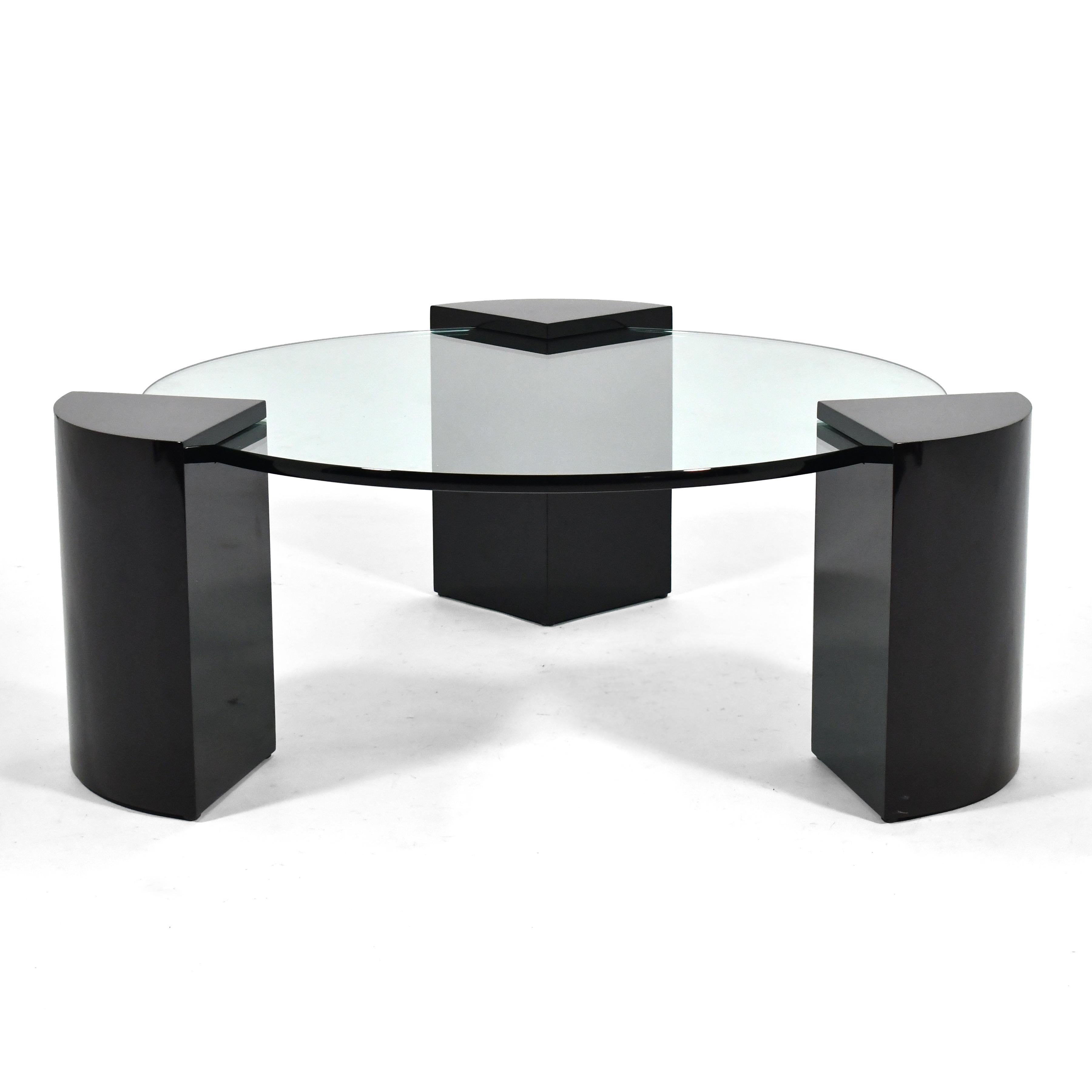 Created for Chicago interior designer Roy Klipp, this stylish coffee table has a terrific modernist design with three pie-shaped legs supporting a round glass top with a bull-nose edge.

Measures: 15.75