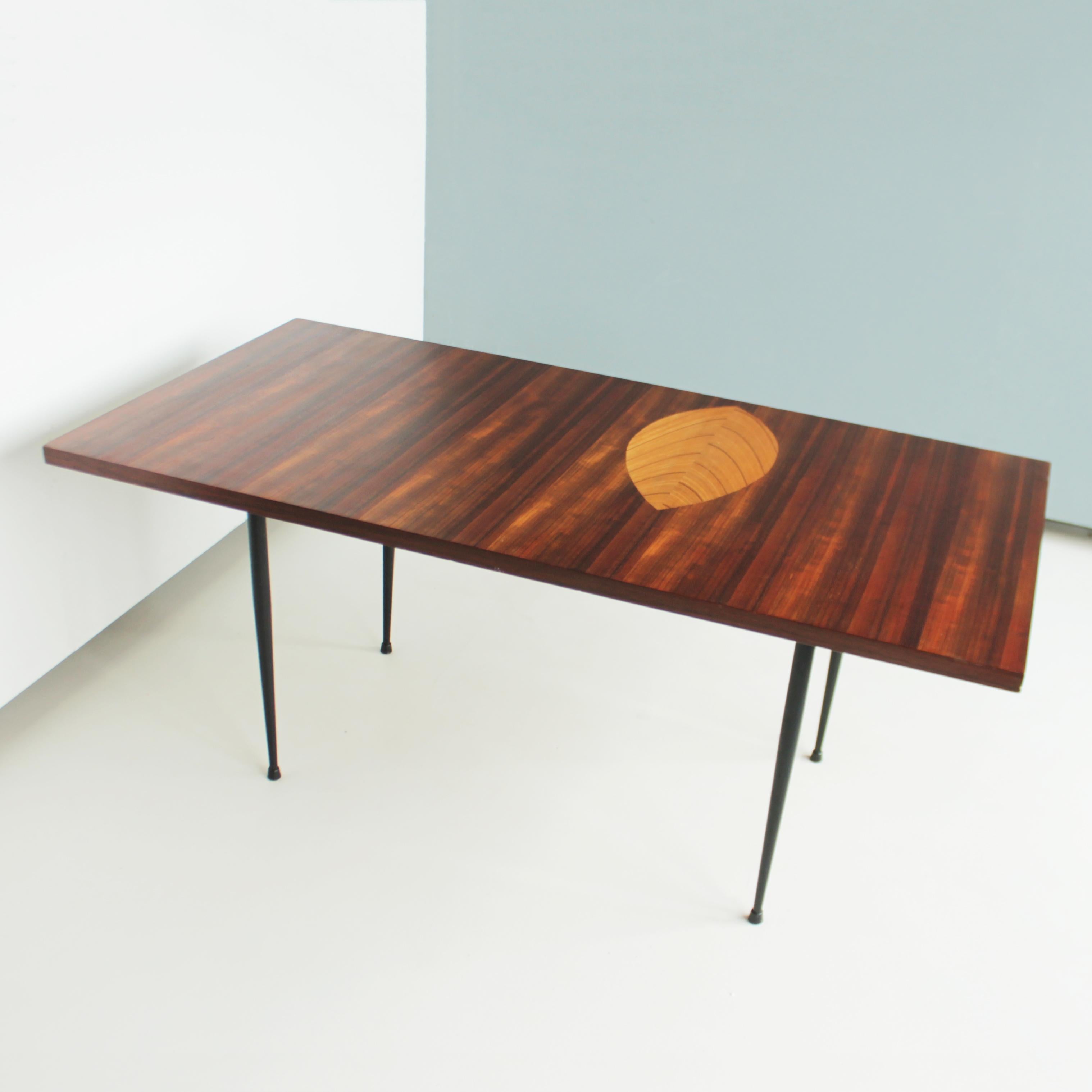 Coffee table by Tapio Wirkkala for Asko Finland, 1958. Model Asko 9013, the laminated birch tree leaf inlaid in the dark padouk. Black lacquered metal legs.
Dimensions: height 20.8 in. (53 cm), length 48.8 in. (124 cm), depth 24.4 in. (62 cm).
