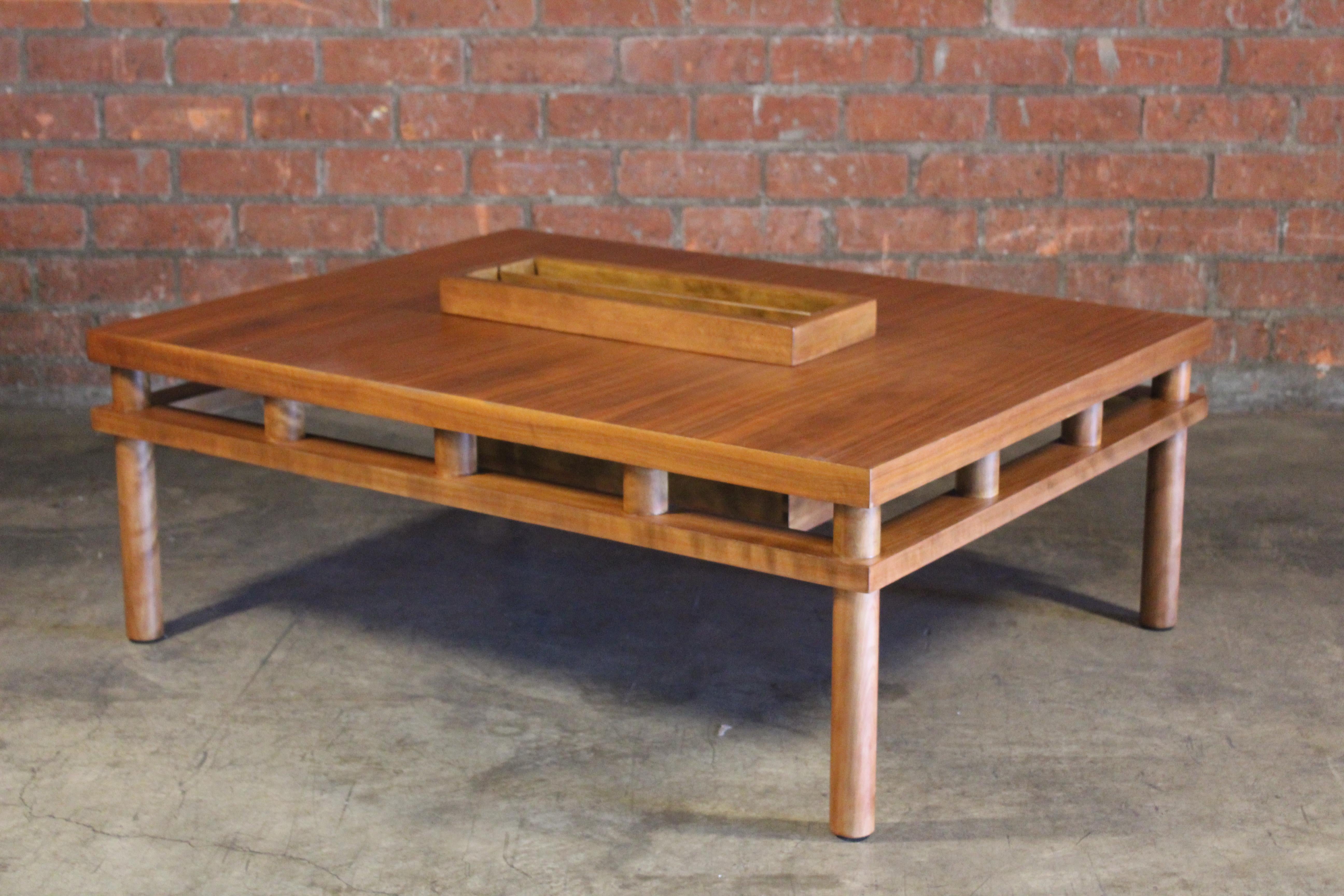 A vintage walnut coffee table with magazine storage designed by T.H Robsjohn-Gibbings, for Widdicomb, 1950s. In excellent newly refinished condition.