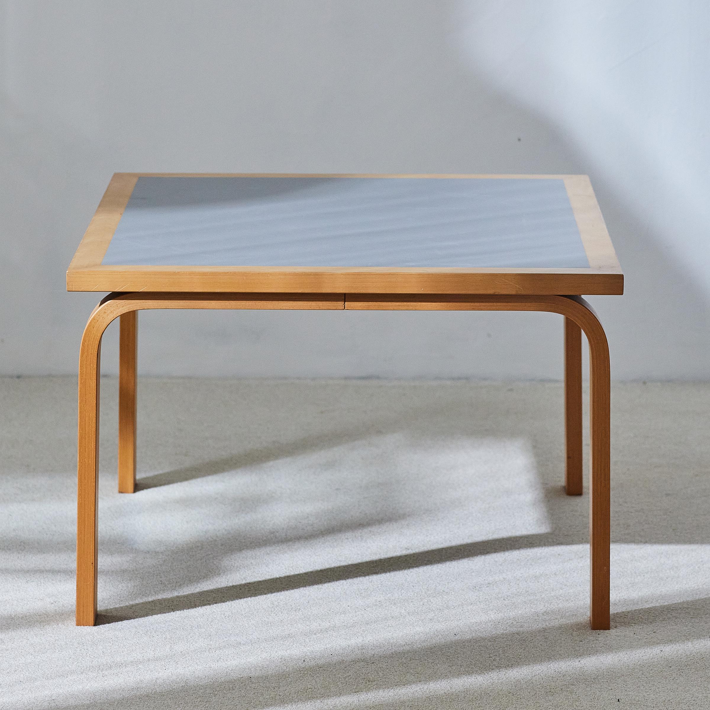 Vintage Danish coffee table designed by Rud Thygesen and Johnny Sørensen for Magnus Olesen and has a frame made of varnished beech with a laminated tabletop.