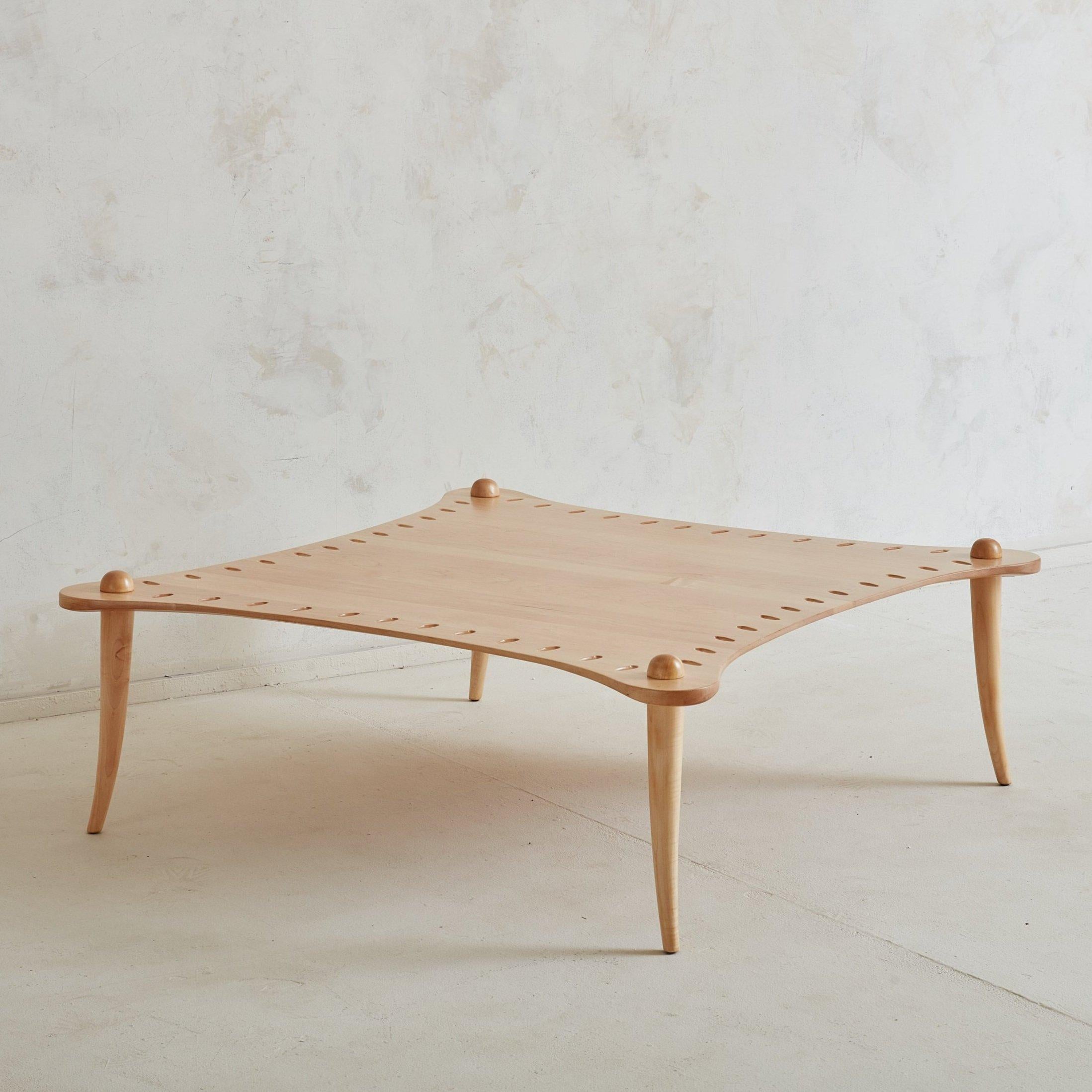 A curved vintage coffee table designed by Valérie Dementhon in 1991 for Artelano, which has been a French editor of high end furniture since 1972. 
DIMENSIONS: 43