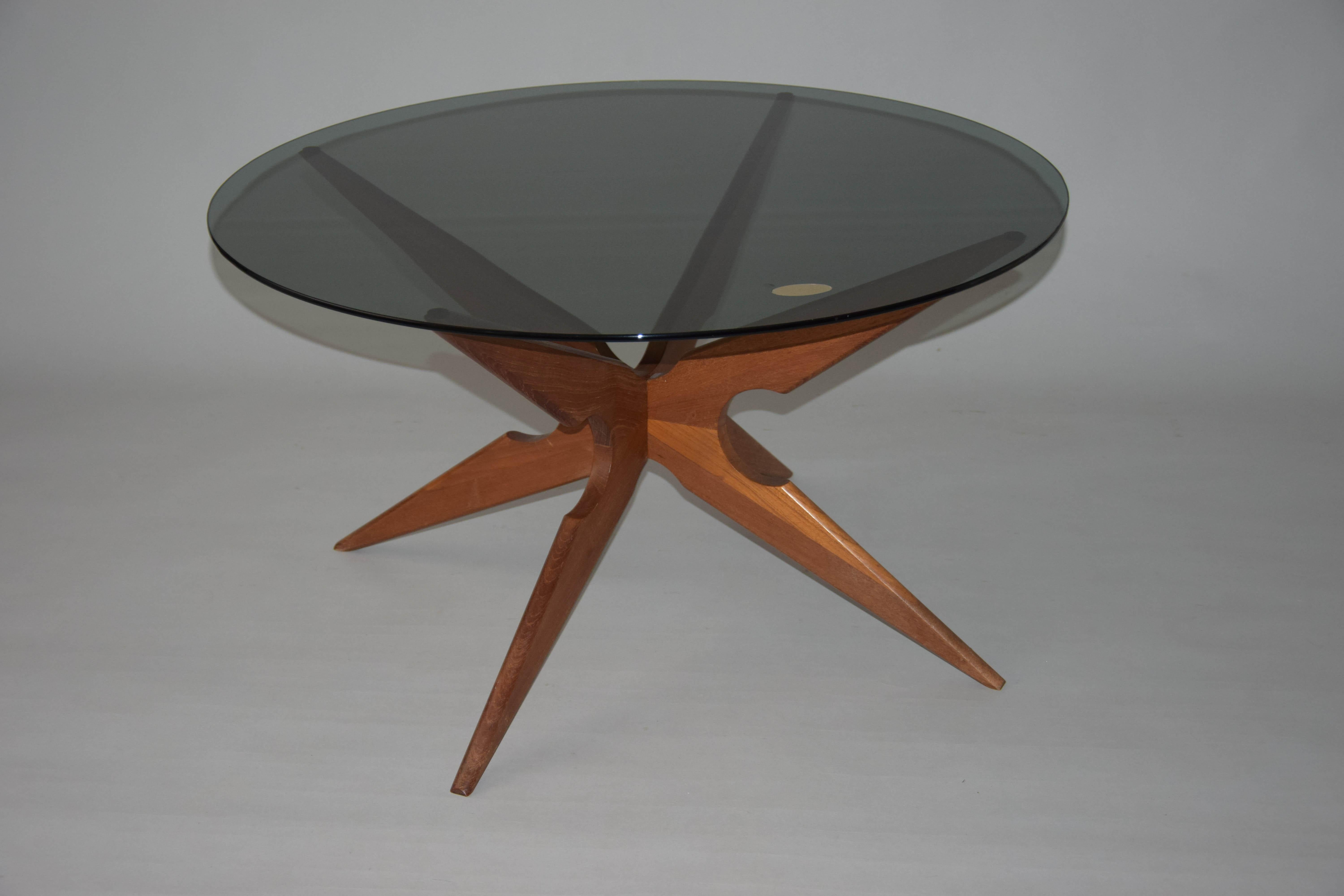Table basse rétro design attribuée à Vladimír Kagan, fabriquée en Belgique, années 1960, pieds en bois, verre fumé, étiquette originale en papier Mobler.
 