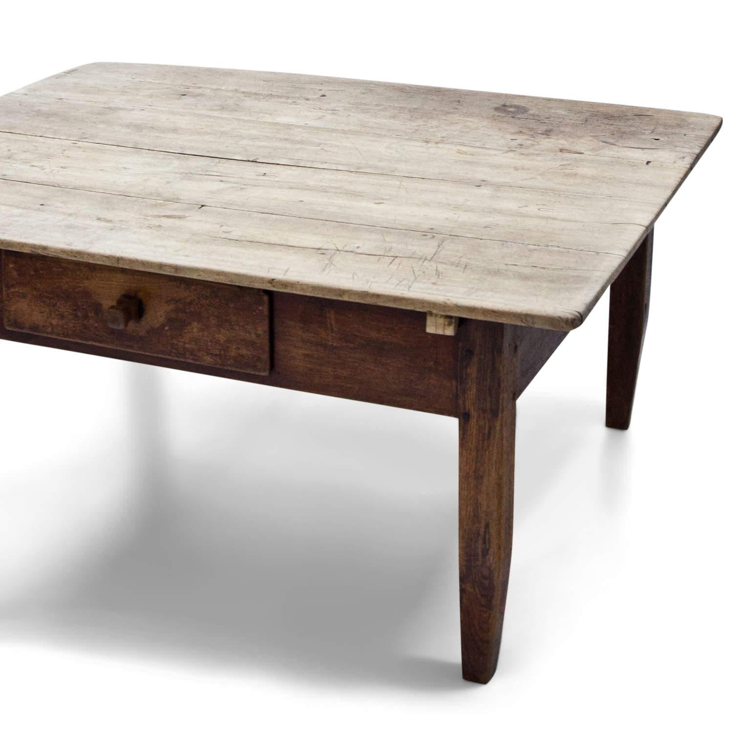 Low coffee table with one drawer and short legs. The tabletop is maple, the base is pine. The table has its unusual height since the legs were shortened later. Very nice naturally aged patina.