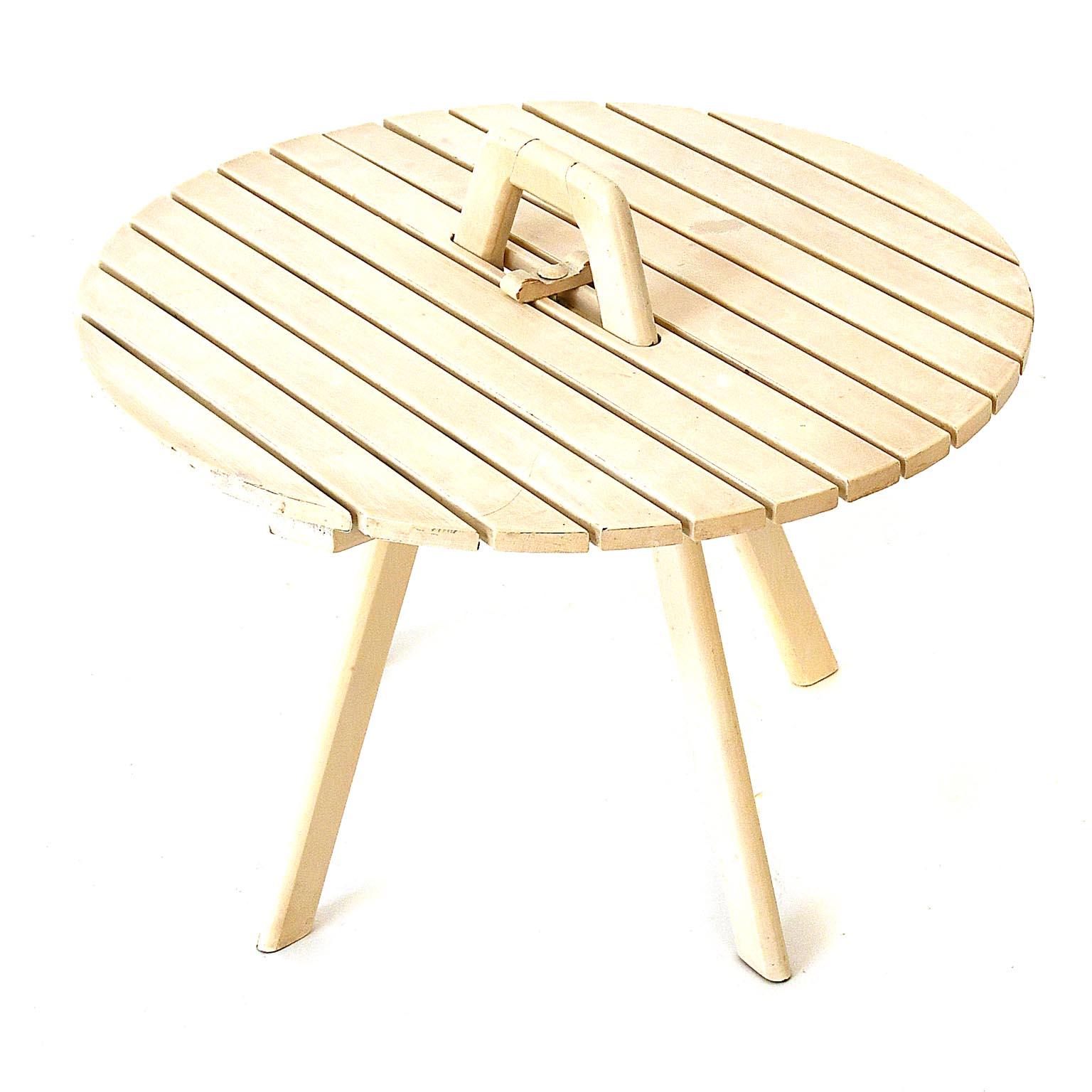 Dismountable table made by Clairitex Paris. The piece is in its original condition, white lacquered, partly the lacquer is slightly rubbed off. The piece can be disassembled. The table top is fixed with a wooden screw in the middle as well as the