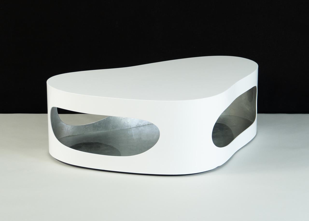 Low coffee table sculpted by Jacques Jarrige and finished with white lacquer exterior and silver leaf interior.