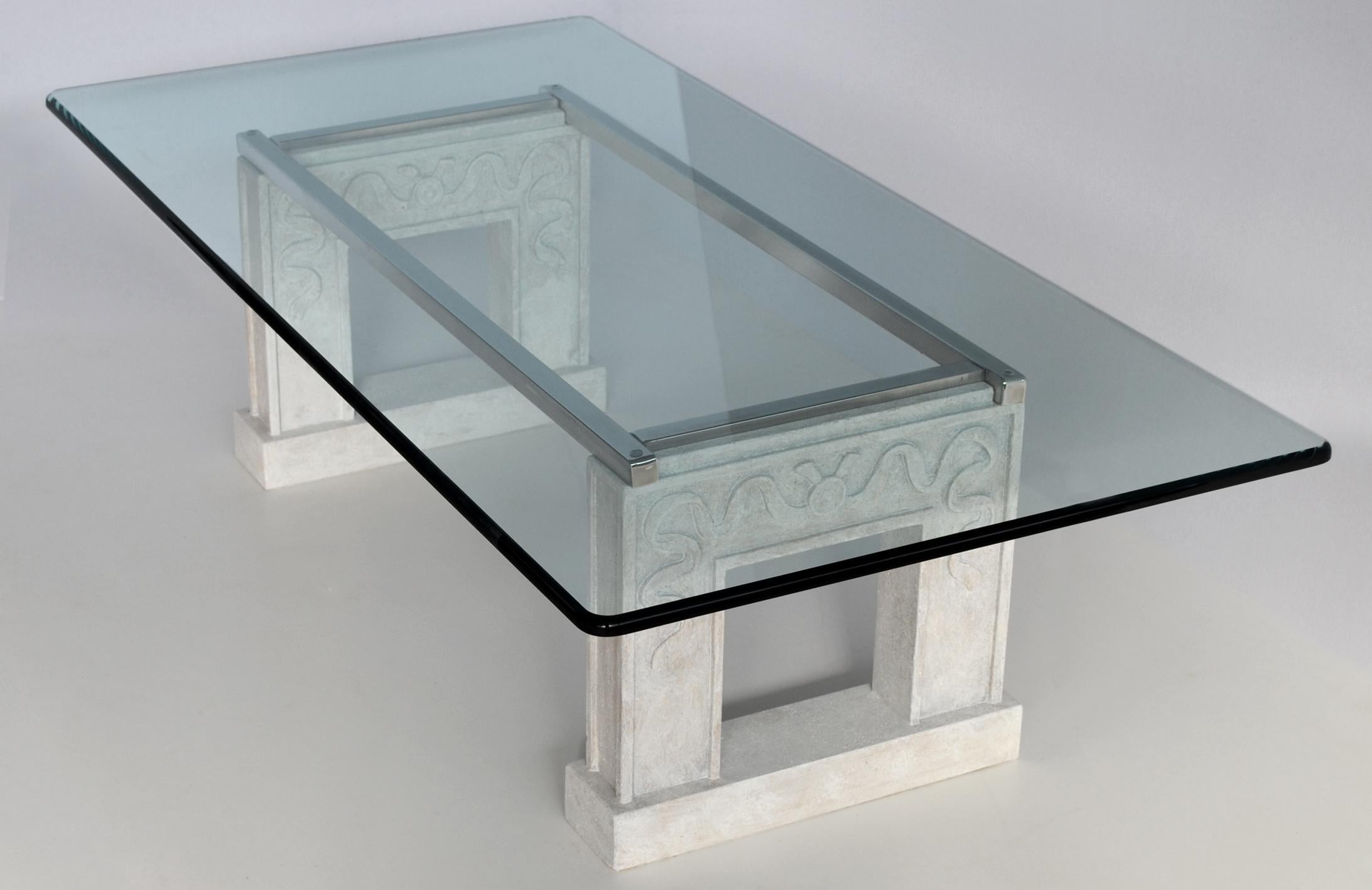 This elegant coffee table in contemporary style with bright colors is suitable for your living room. Rectangular Extra light crystal glass top embellished by a shaped edge of 2 cm thickness and supported by two carved beige stone bases joined by