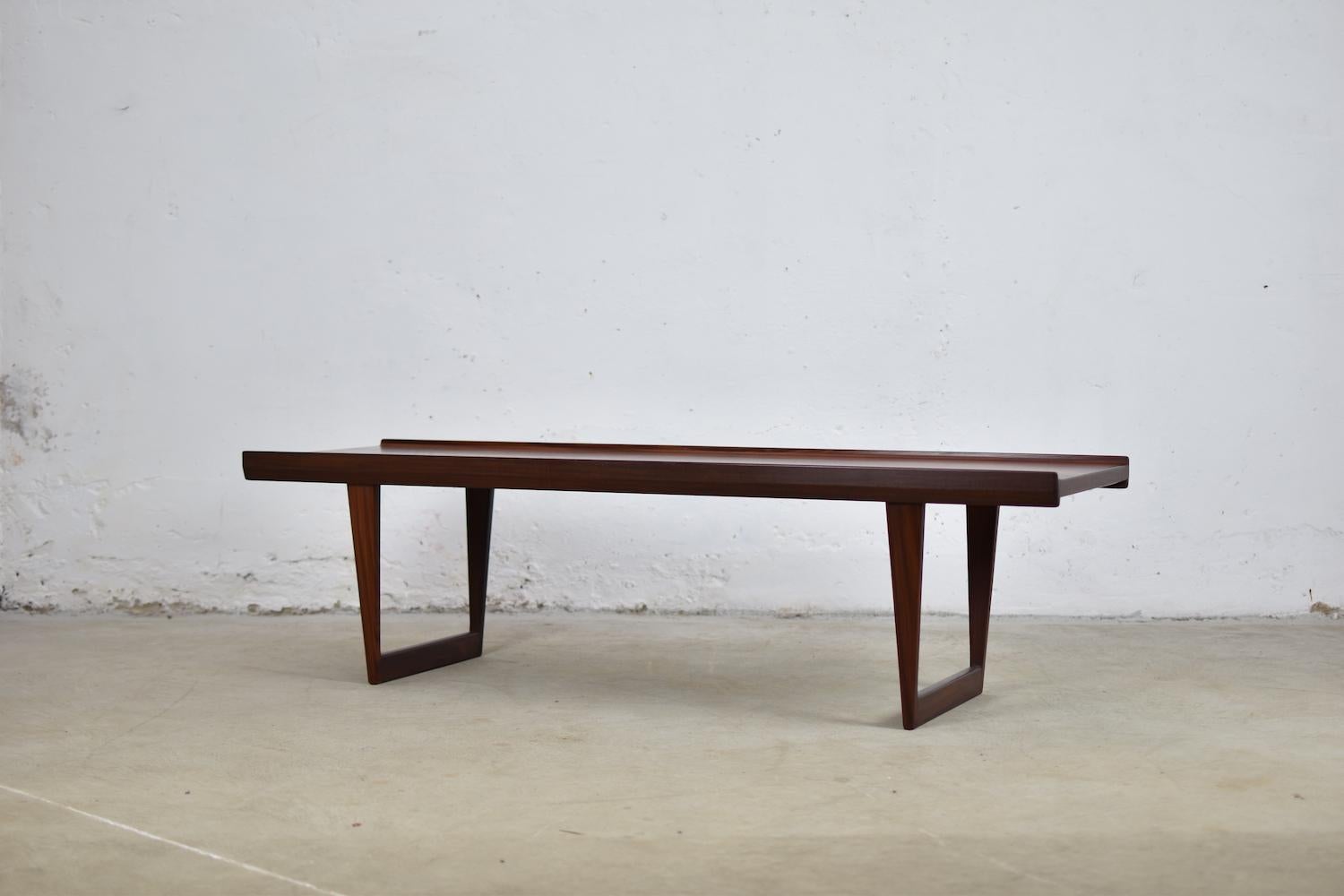 Lovely coffee table designed by Peter Løvig Nielsen for Løvig, Denmark, 1965. This table or bench features a teak slated base and a teak top with raised edges. Labeled underneath.