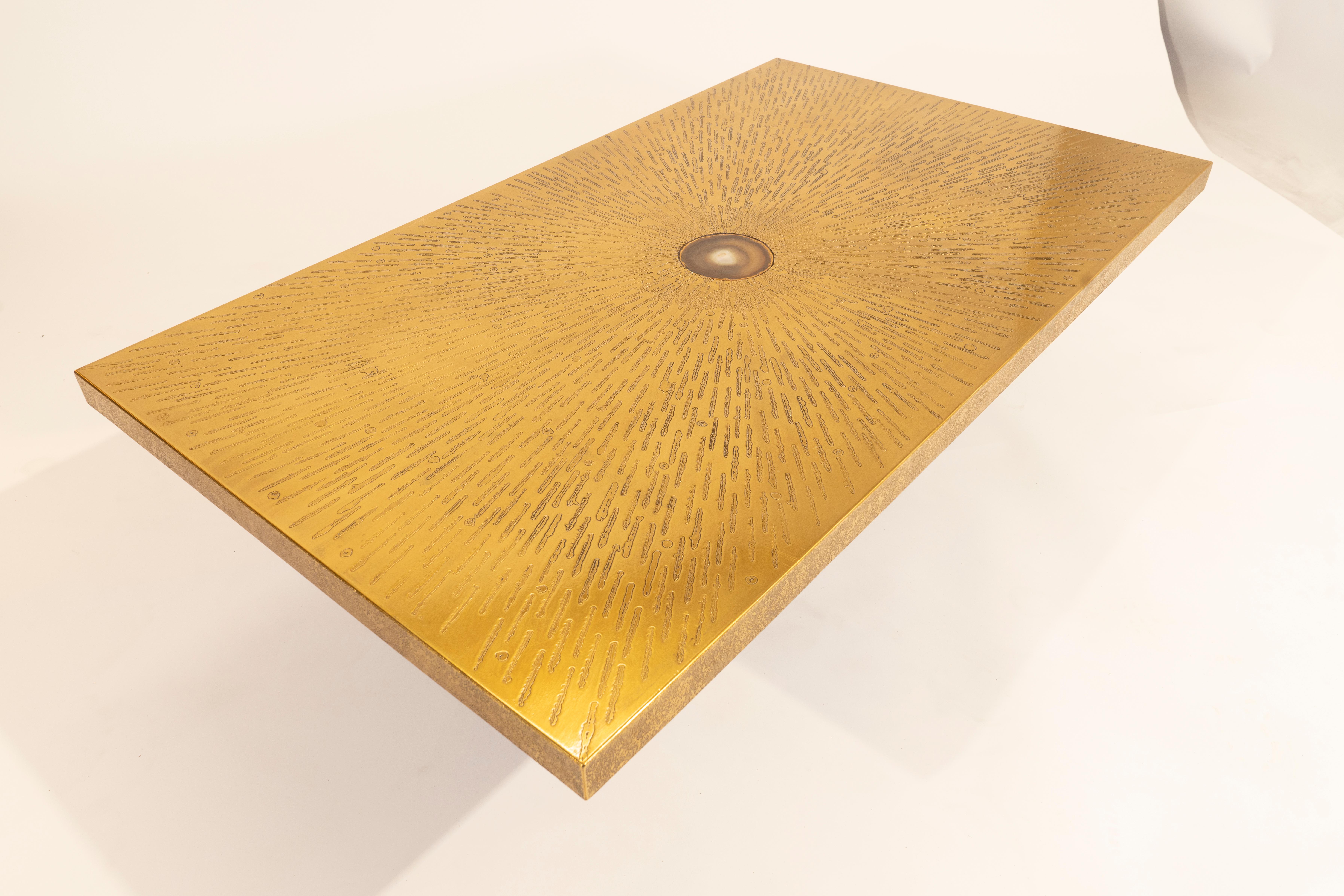 Coffee table etched brass inlaid agate By Willy Daro in perfect condition.  An iconic motif of spider web with an off-center agate.
Rare and Different base that used by the artist, Black metal. Special order.
From the same school of Georges Mathias,