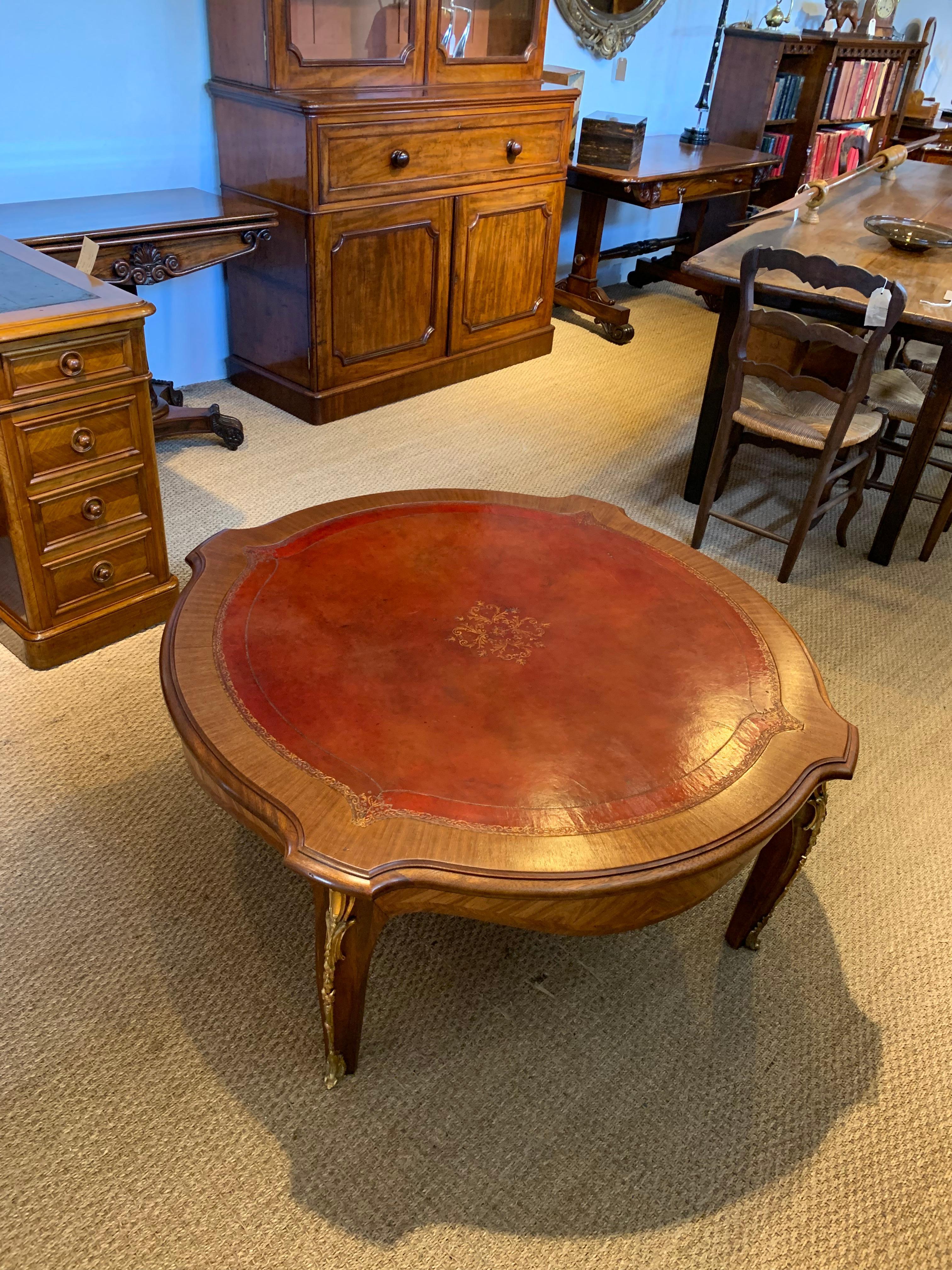 Great early 20th century leather topped coffee table 

French dating to circa 1920s with original leather top and ormolu mounts 

Measures: Height 20 inches 
Width 47 inches 
Depth 47.