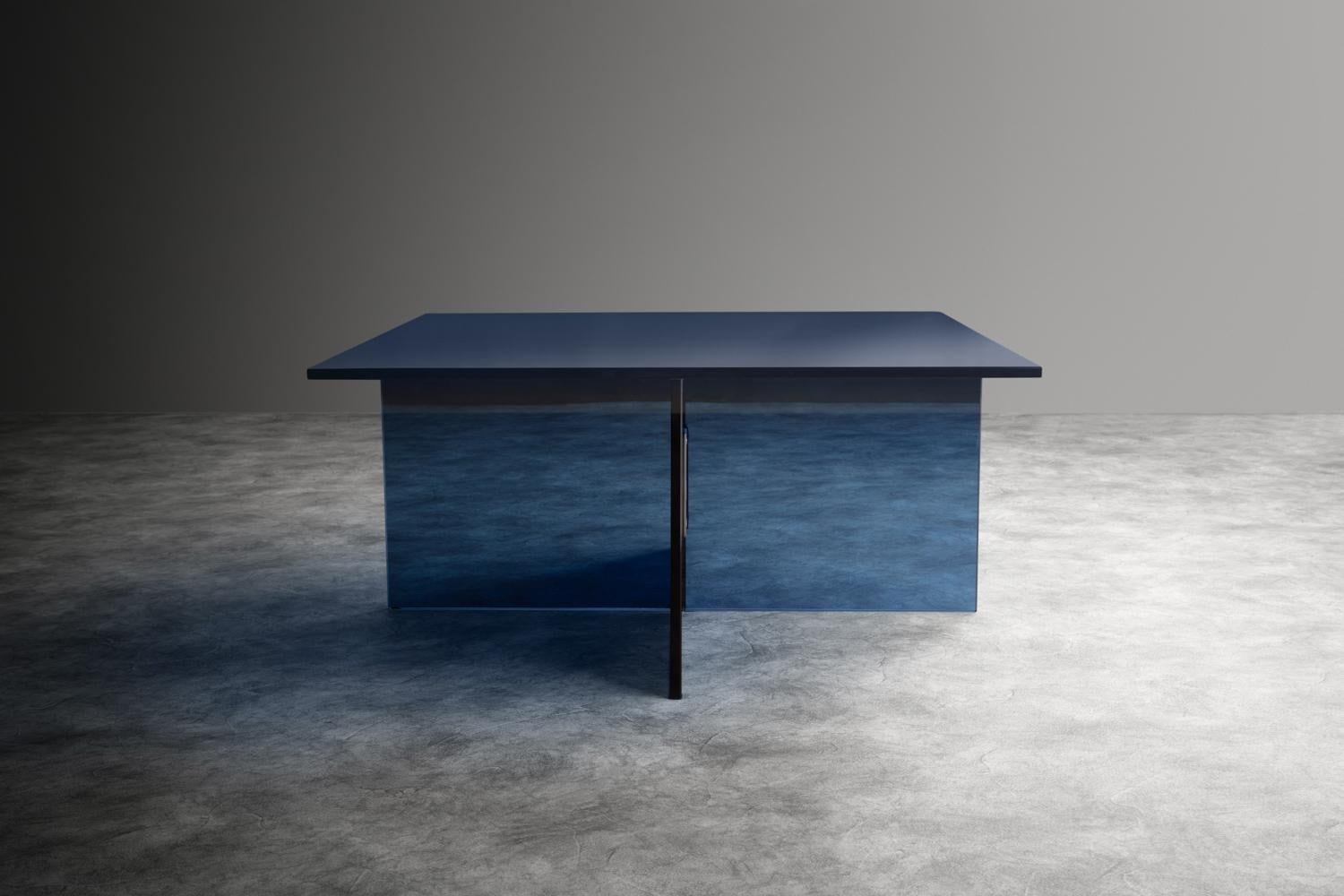 Clear blue glass coffee table, metal bracket, X shaped base.