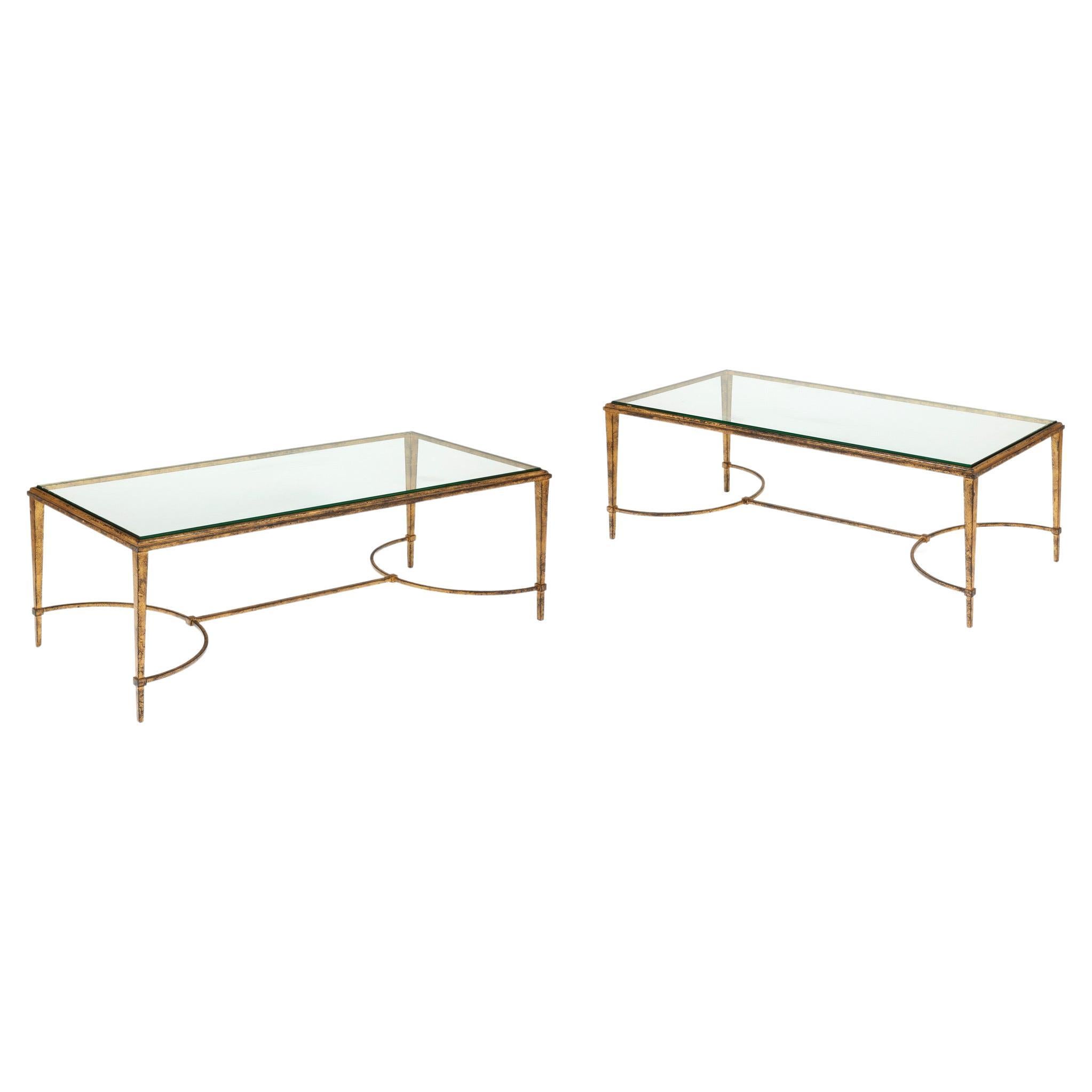 Coffee table in gilded wrought iron with a rectangular glass slab top on a corner base with tapered legs and a double arch brace. A pair is available.
Origin : Lee Bouvier Radziwill's collection.