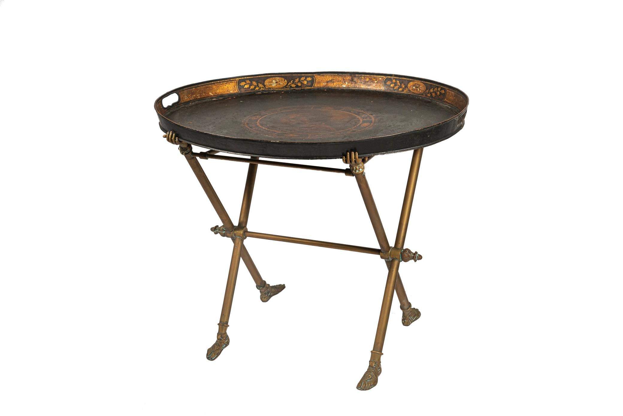 Coffee table,
Sheet metal tabletop decorated in the style of antique Rome with a medallion decorated with a gallant couple,
Bronze foot in the shape of antique sandals, tabletop grips in the shape of hands,
France, circa 1940.

Measures: Width 66