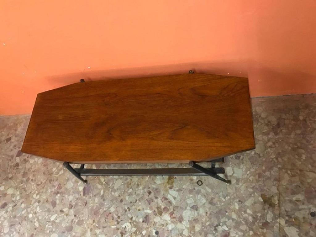 Coffee table form 1960s Italy with wooden top and metal frame with brass feet in good condition for vintage furnishings.