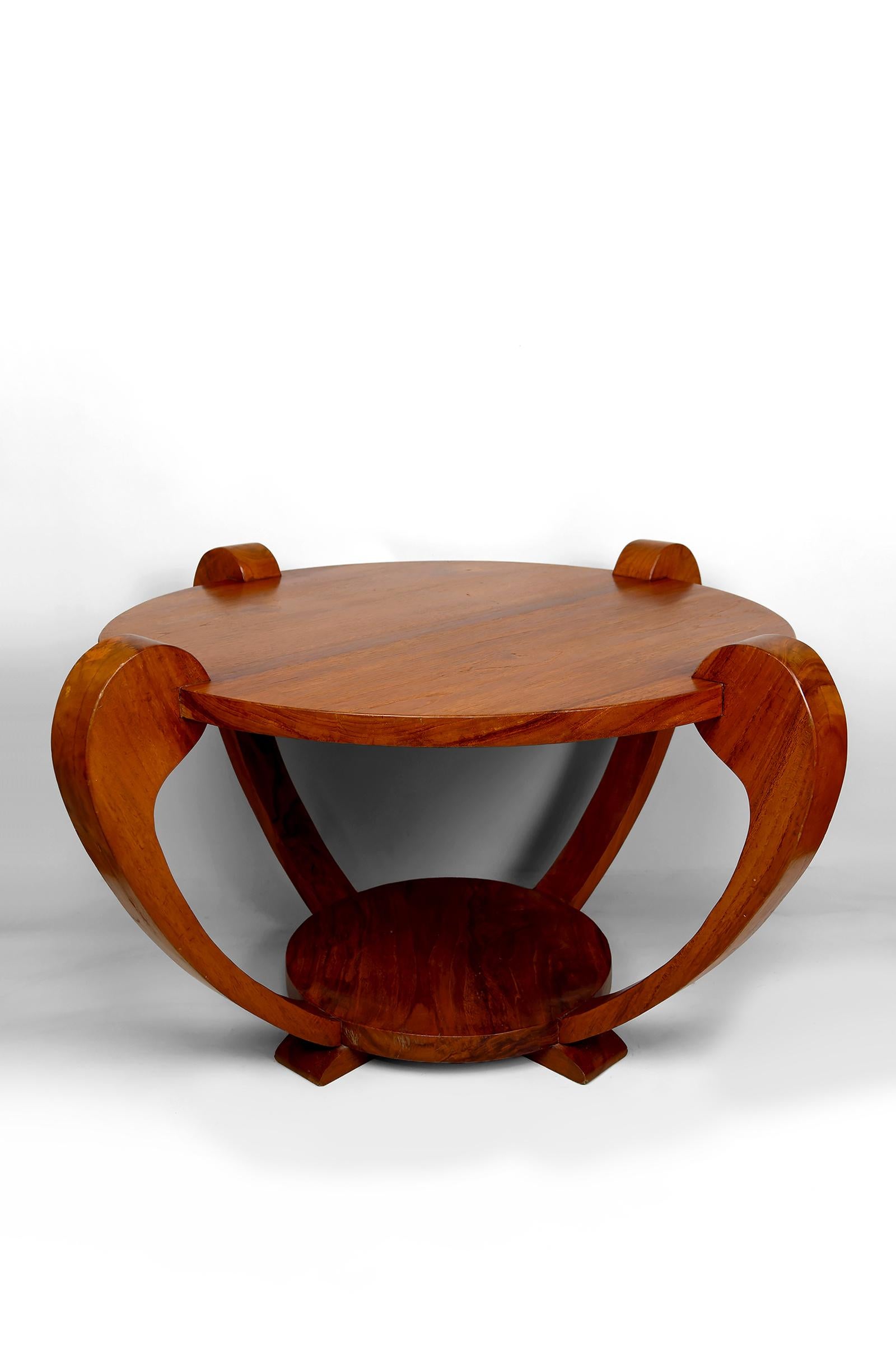 Teak Solid Wood Coffee Table / Gueridon, Colonial Art Deco, In the Style of Michel Dufet, Circa 1930

Coffee table / gueridon made of solid teak wood with a circular top.

Base composed of four curvilinear legs joined by a stretcher shelf, resting