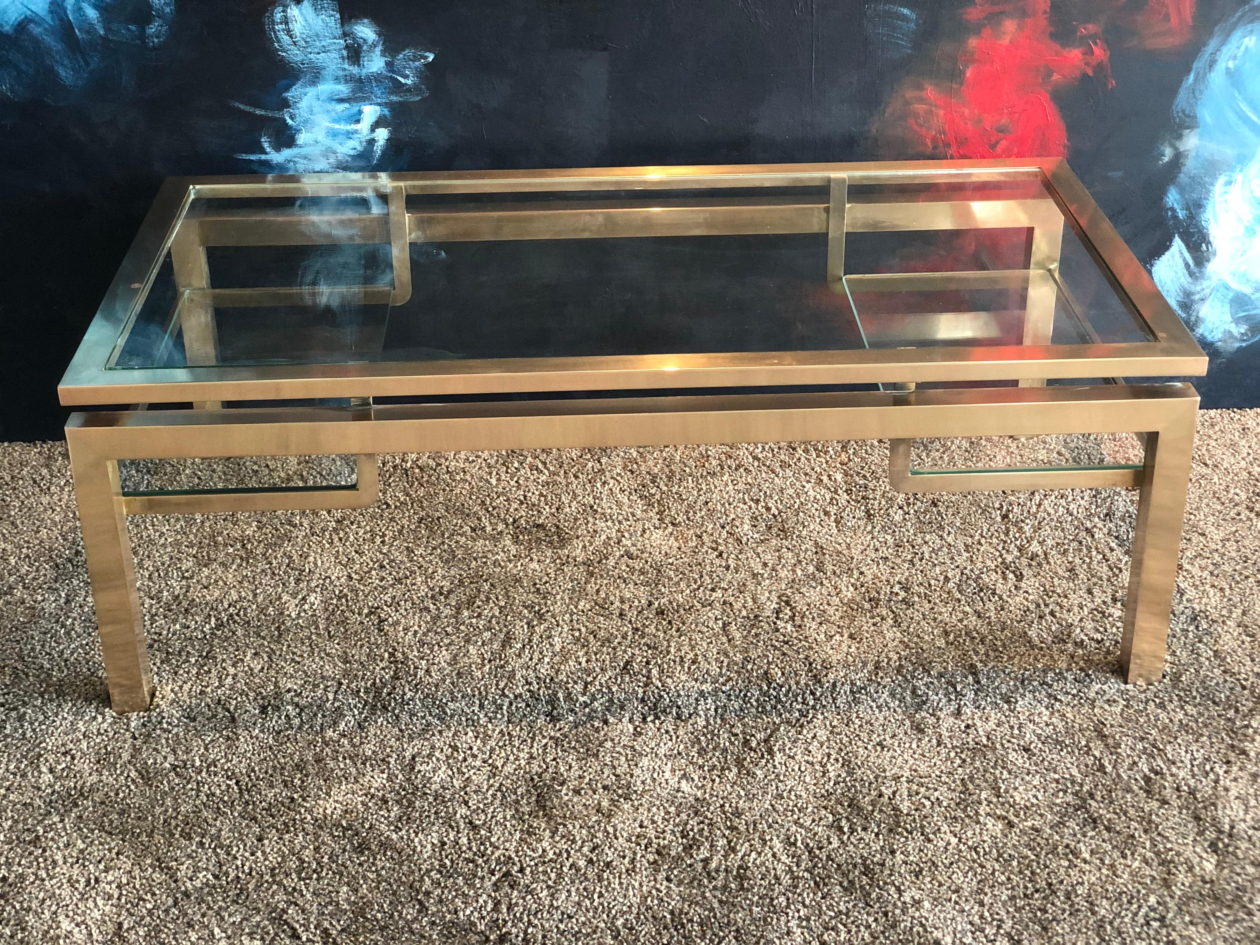 Rectangular brass coffee table by Guy Lefevre for Maison Jansen published in the 1970s. Two shelves in good condition. Measures: Length 127, width 67, height 38.