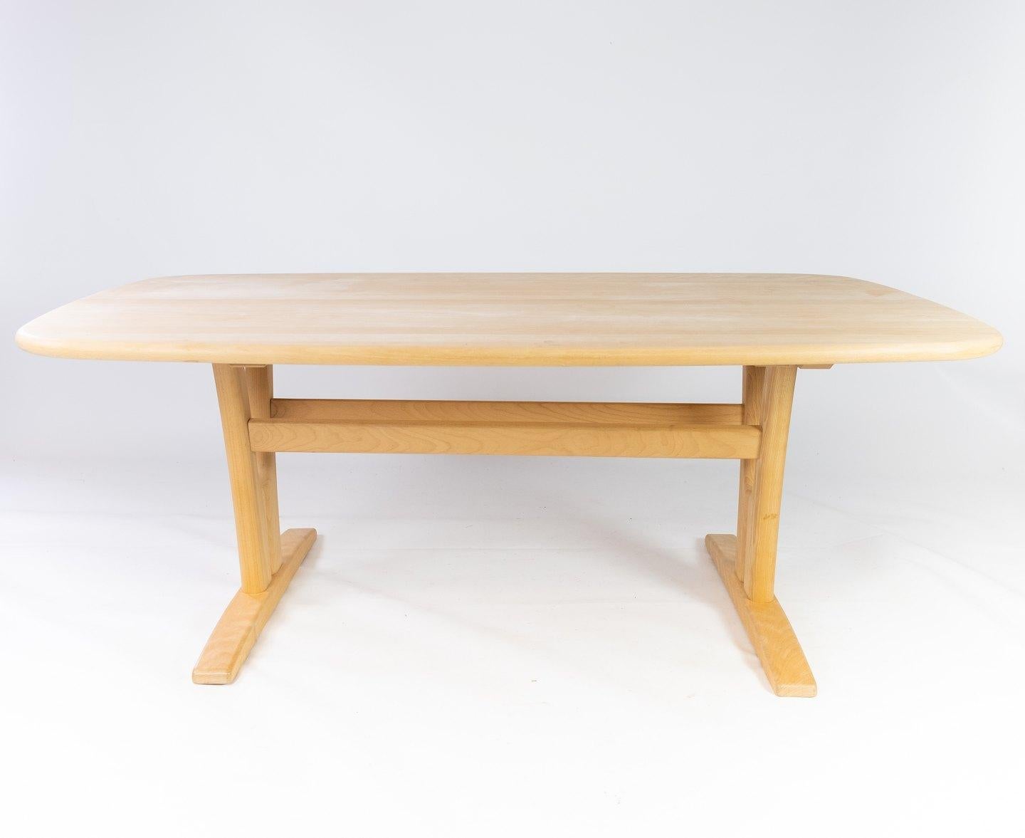 This Danish-designed coffee table, crafted by the renowned Skovby Furniture factory in the 1960s, embodies the essence of mid-century modern style. Constructed from sturdy beech wood, it showcases the era's emphasis on clean lines, organic shapes,
