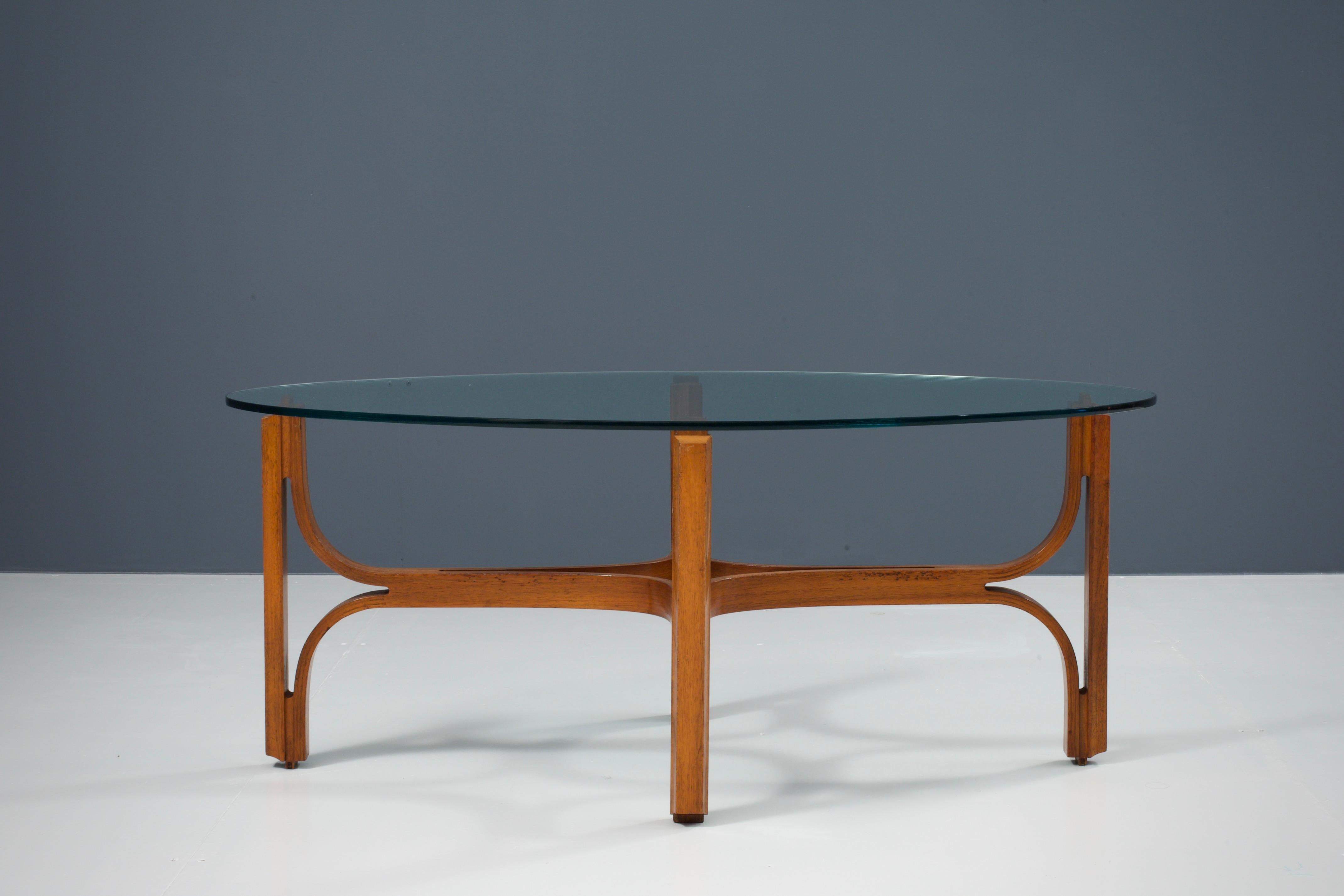 Coffee table in bended walnut and glass, Italy, 1960s

This organic shaped table is the work of true Italian craftsmanship. From above, through the oval shaped glass plate, an exceptional wooden construction is visible. It’s formed by ingeniously