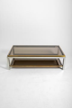 Mesa baja de latón cromado y cristal, firmada Jean Charles