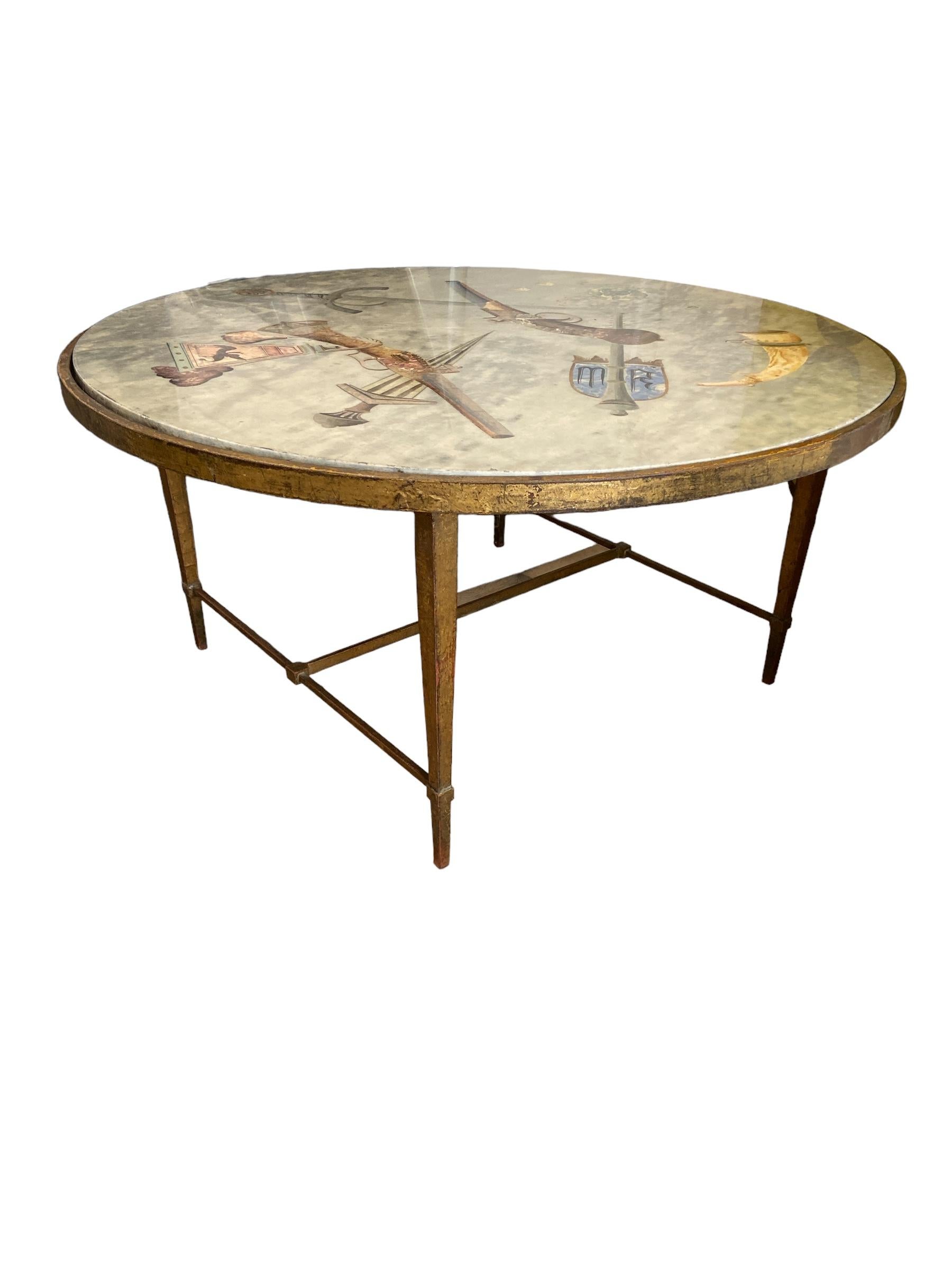 Italian coffee table with a base in bronze and a painted marble top.
The representations show various stabbing weapons and firearms.
Also on display are a battle flail, powder horn, dice, and shield with the
initials MR. This piece is from NATO,