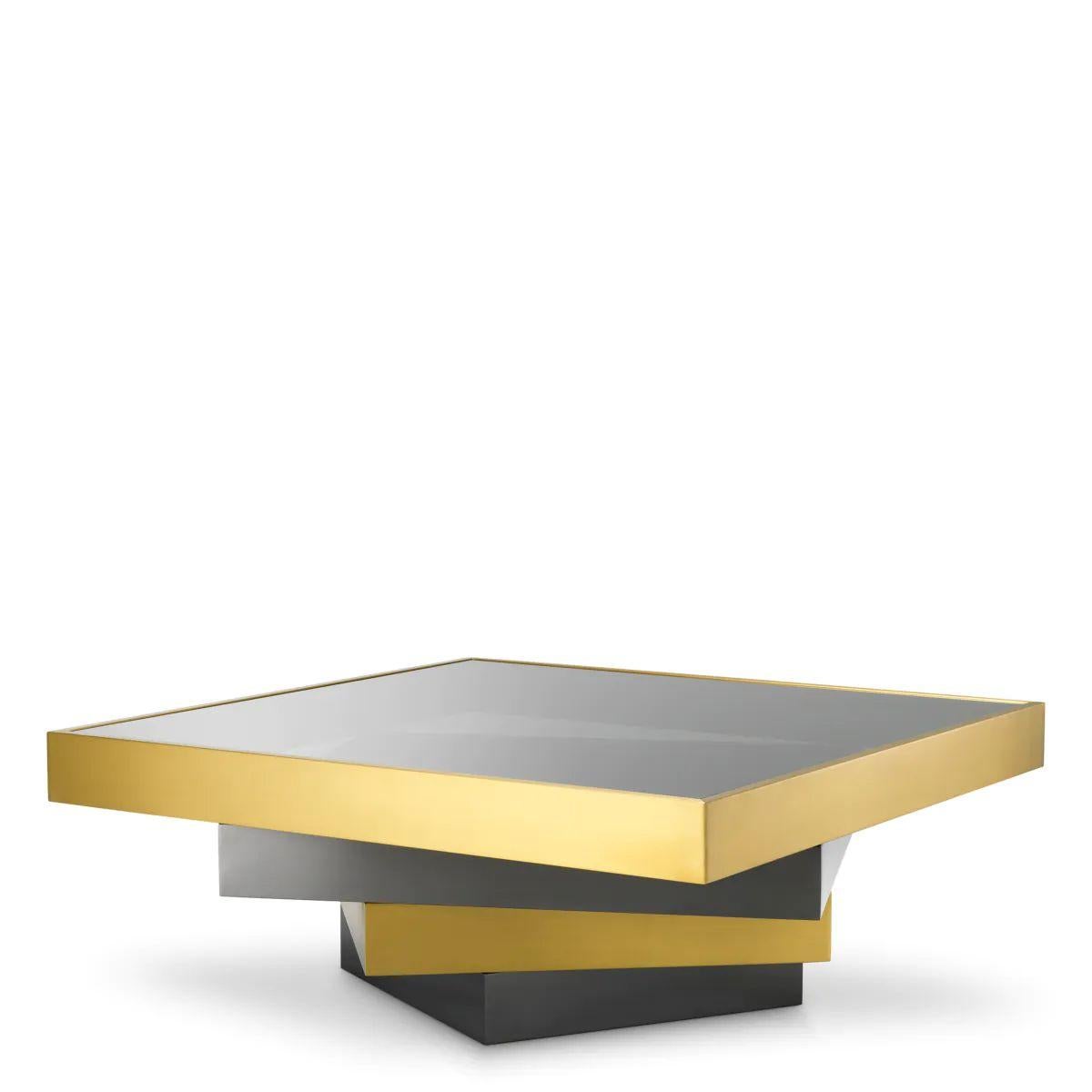 Coffee table in brushed brass, bronze finish, and smoked glass, this contemporary piece stands out for its clean geometry and refined material contrast. The combination of brushed brass, bronze detailing, and a smoked glass top creates a coffee