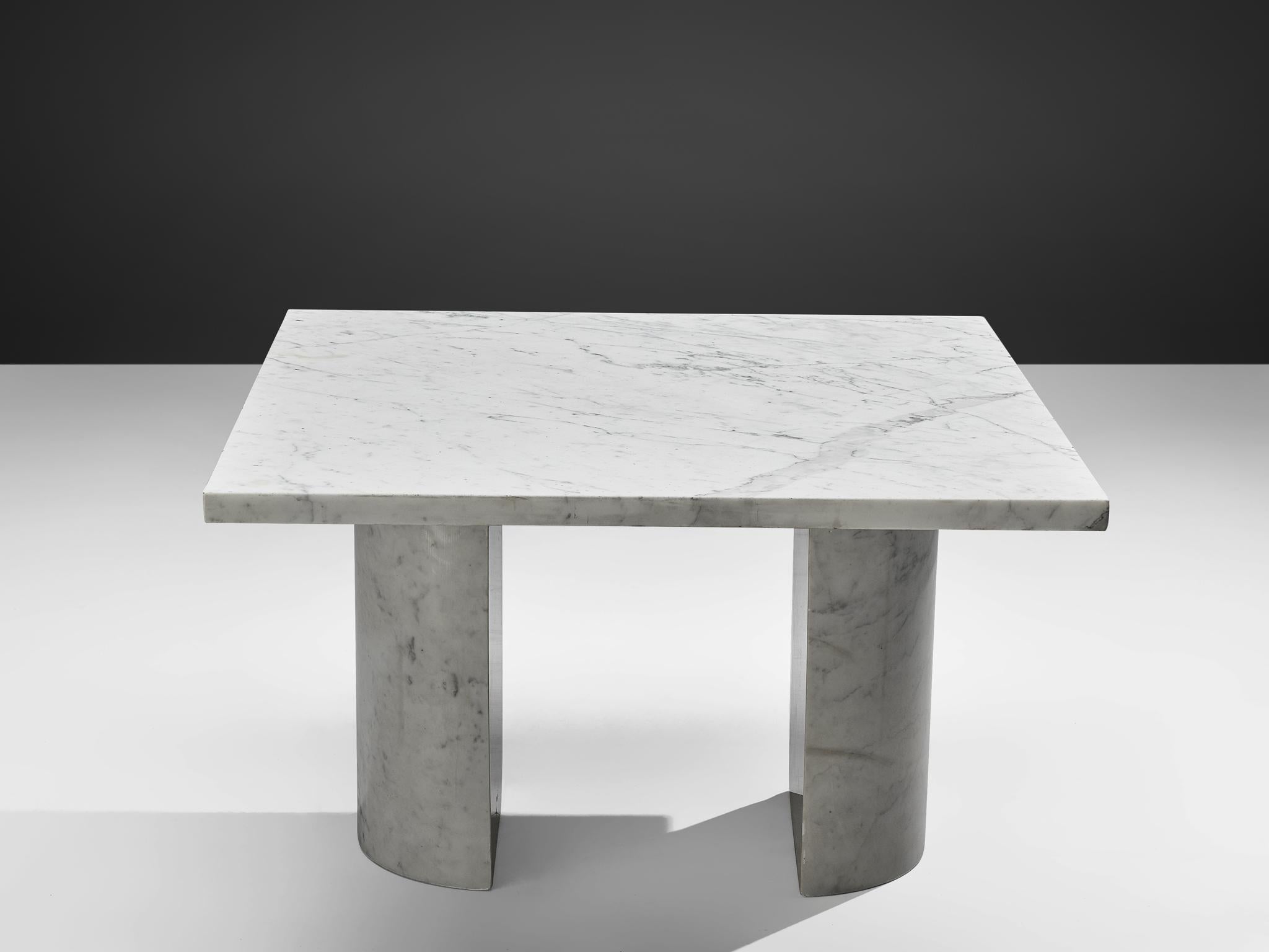 Coffee table, marble, Italy, 1970s.

This cocktail table features a rectangular shaped marble tabletop. The top is supported by two semi-circular columns. The aesthetics are archetypical for postmodern design, bearing references to architectural