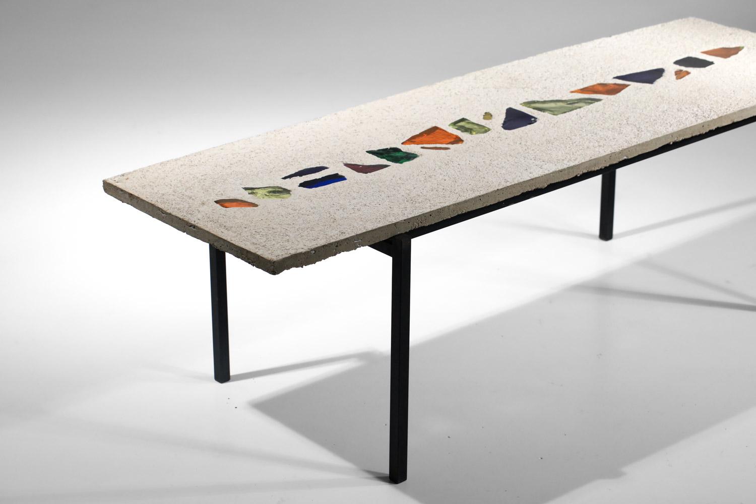 Long French coffee table from the '80s in the style of Jacques Avoinet's work. Hand-crafted, concrete slab with colored glass inlays, resting on a black lacquered steel base (original paint). Beautiful vintage condition, with slight traces of age