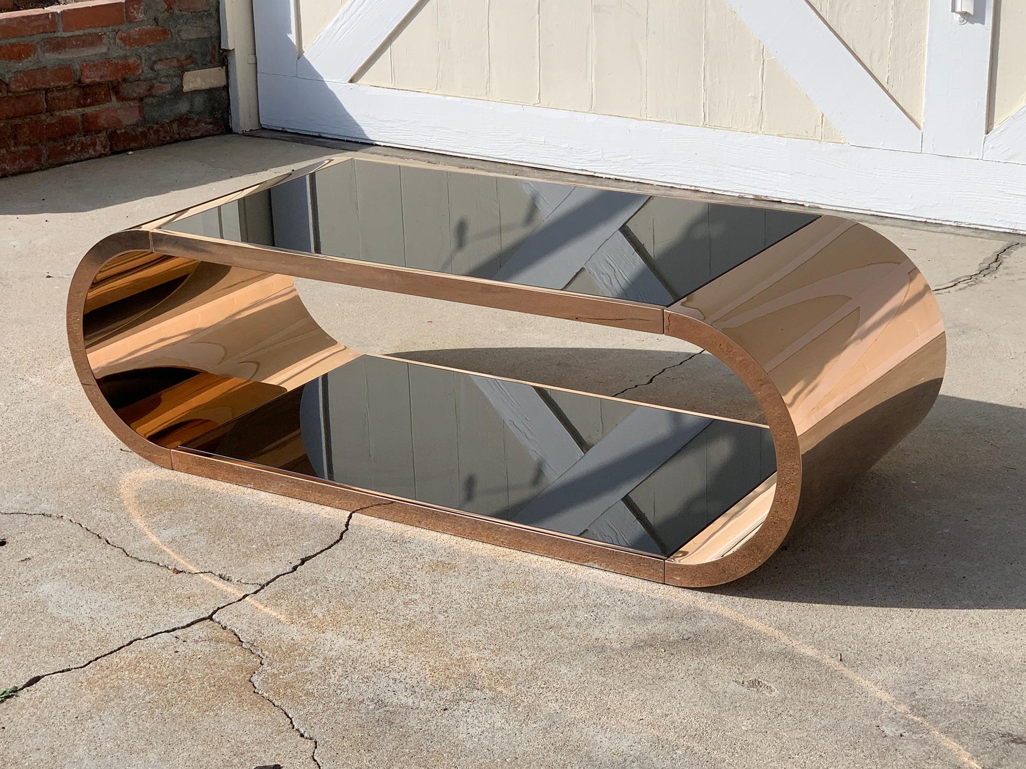 Stunningly beautiful coffee table made in metal and copper plated (we can have it replated in your choice of metal for an additional fee and 3 weeks lead time).
The table has a bottom and top shelves that are black (the glass has a film under