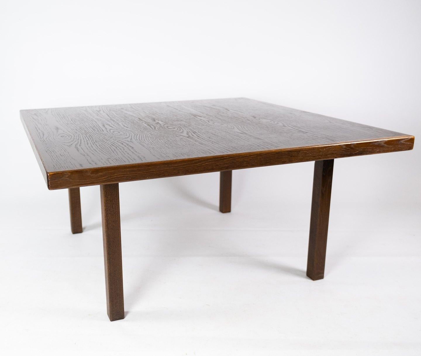 
This Danish-designed coffee table from the 1960s exudes timeless elegance and practicality. Crafted from dark oak, it boasts a rich, sophisticated finish that adds warmth to any living space.

With its clean lines and understated design, this