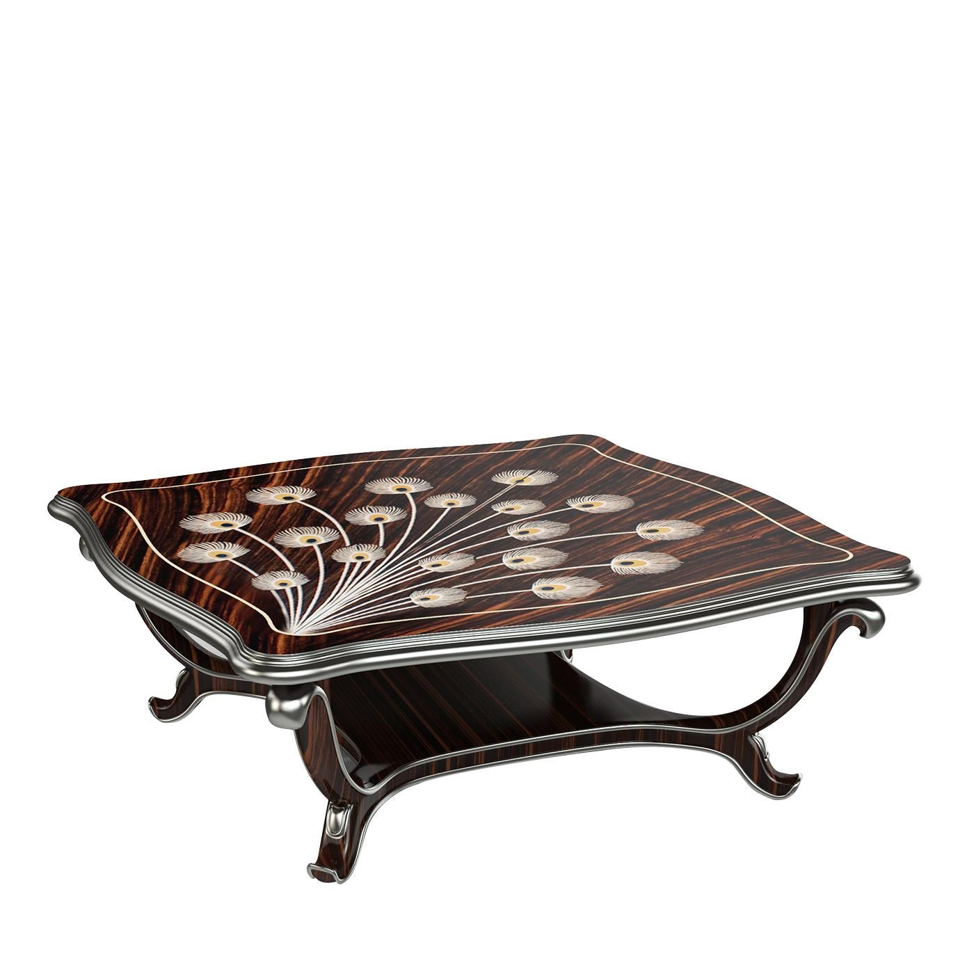 A plush and elegant piece of functional decor, this coffee table is an example of impeccable craftsmanship on refined, exclusive materials. Made of Makassar ebony, the top boasts superb wooden marquetry, resting on a sinuous and regal, Art Deco