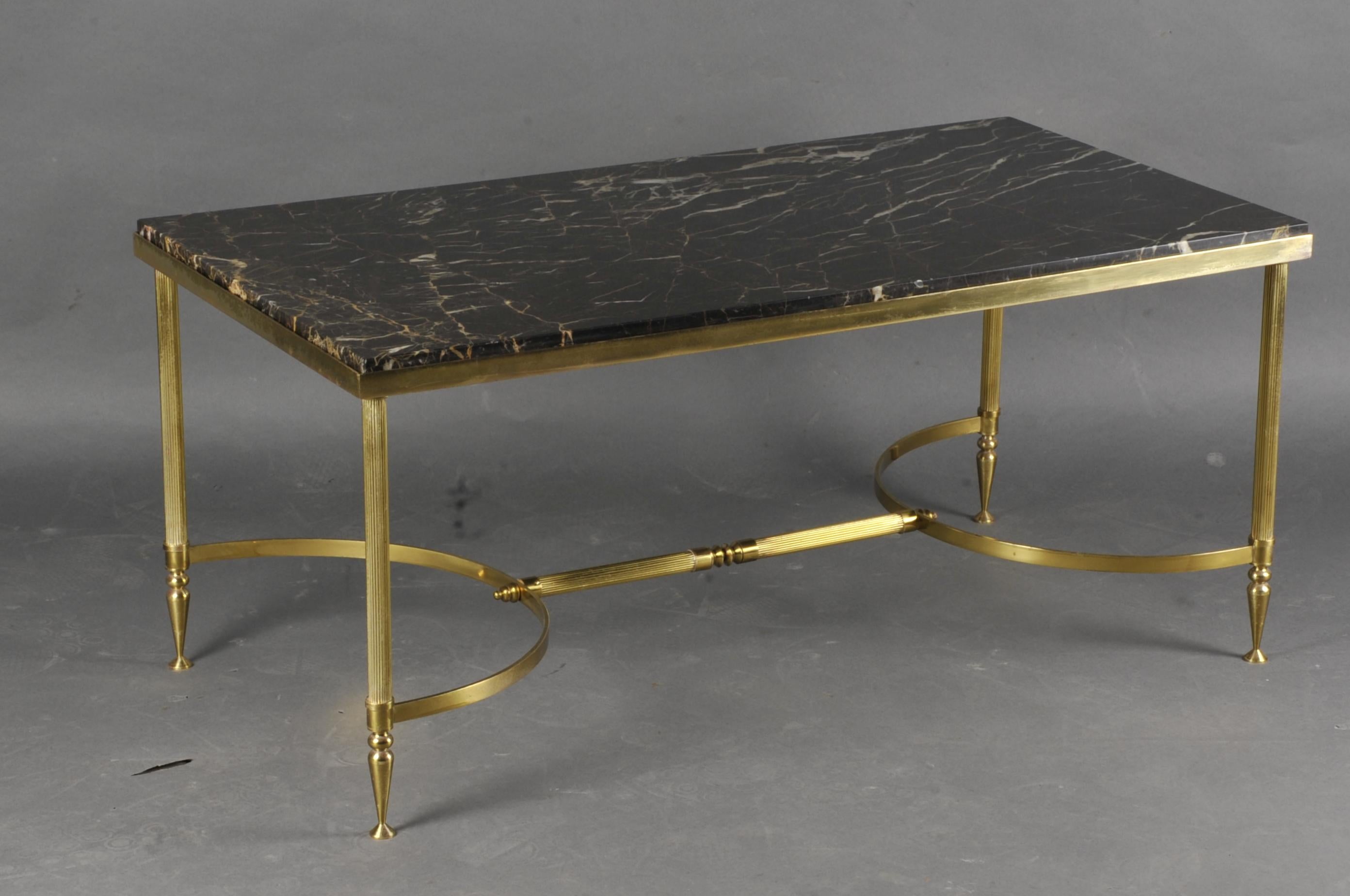 Elegant coffee table from the 60s / 70s in gilded brass on four tubular legs with grooves and joined by a spacer; portor marble top encircled in an ingot mold.

French work of quality.
 