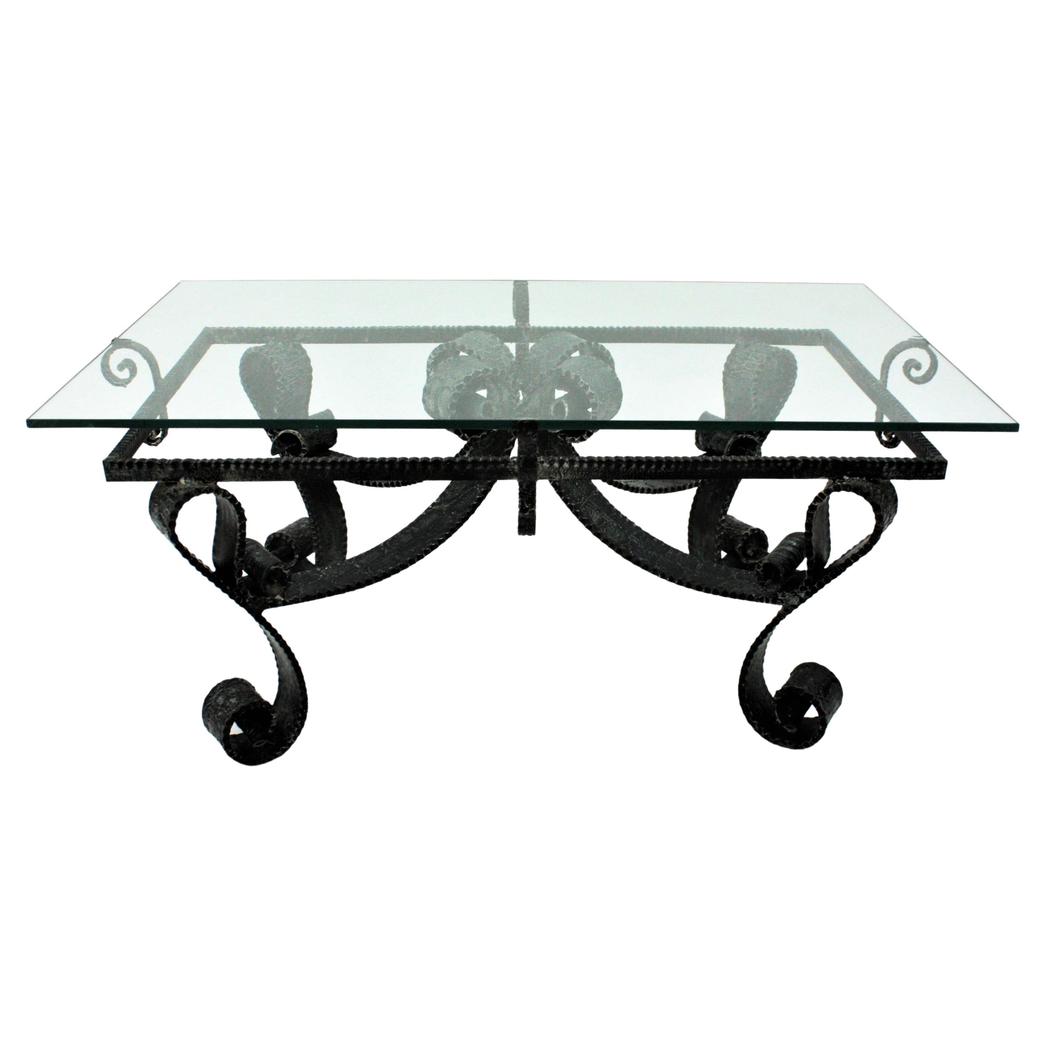Hand wrought iron low table, France, 1960s
This french coffee table has a gorgeous constuction with scrolled legs and scroll detailings on the top and below the glass.
It has a beautiful stretcher joining the four legs.
Very heavyweight
