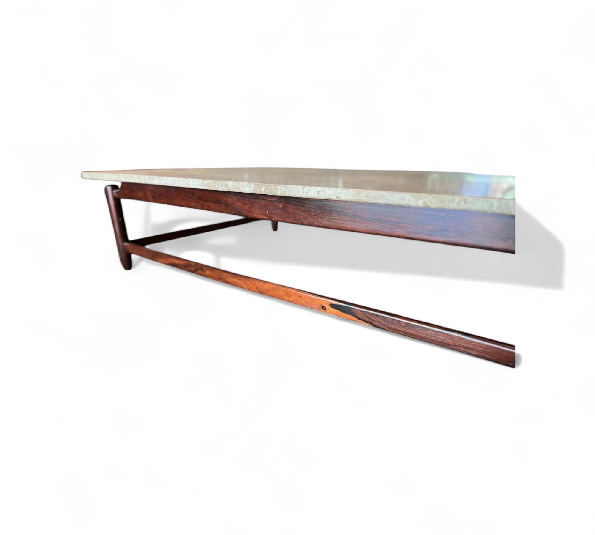 Cette magnifique table basse a ét�é réalisée par Jorge Jabour pour Moveis Cantu au Brésil dans les années 1960 et présente une structure entièrement réalisée en palissandre massif et un plateau en marbre. Les quatre pieds et les poutres ont des bords