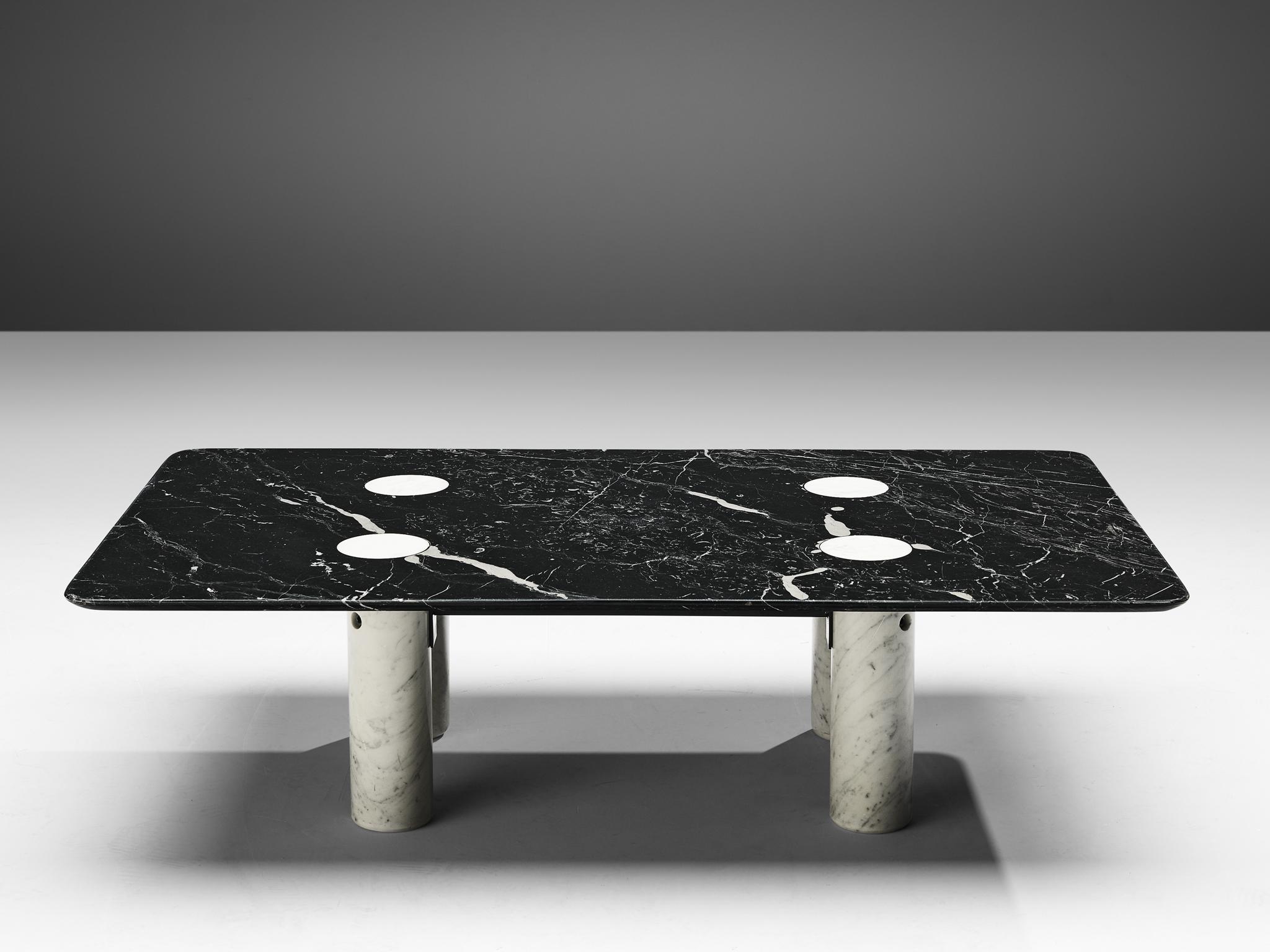 Coffee table, white marble, black marquina marble, metal, Europe, 1970s.

This sculptural side table is a skillful example of postmodern design. The square table has a black marble table top with rounded edges and four white marble cylinder shaped